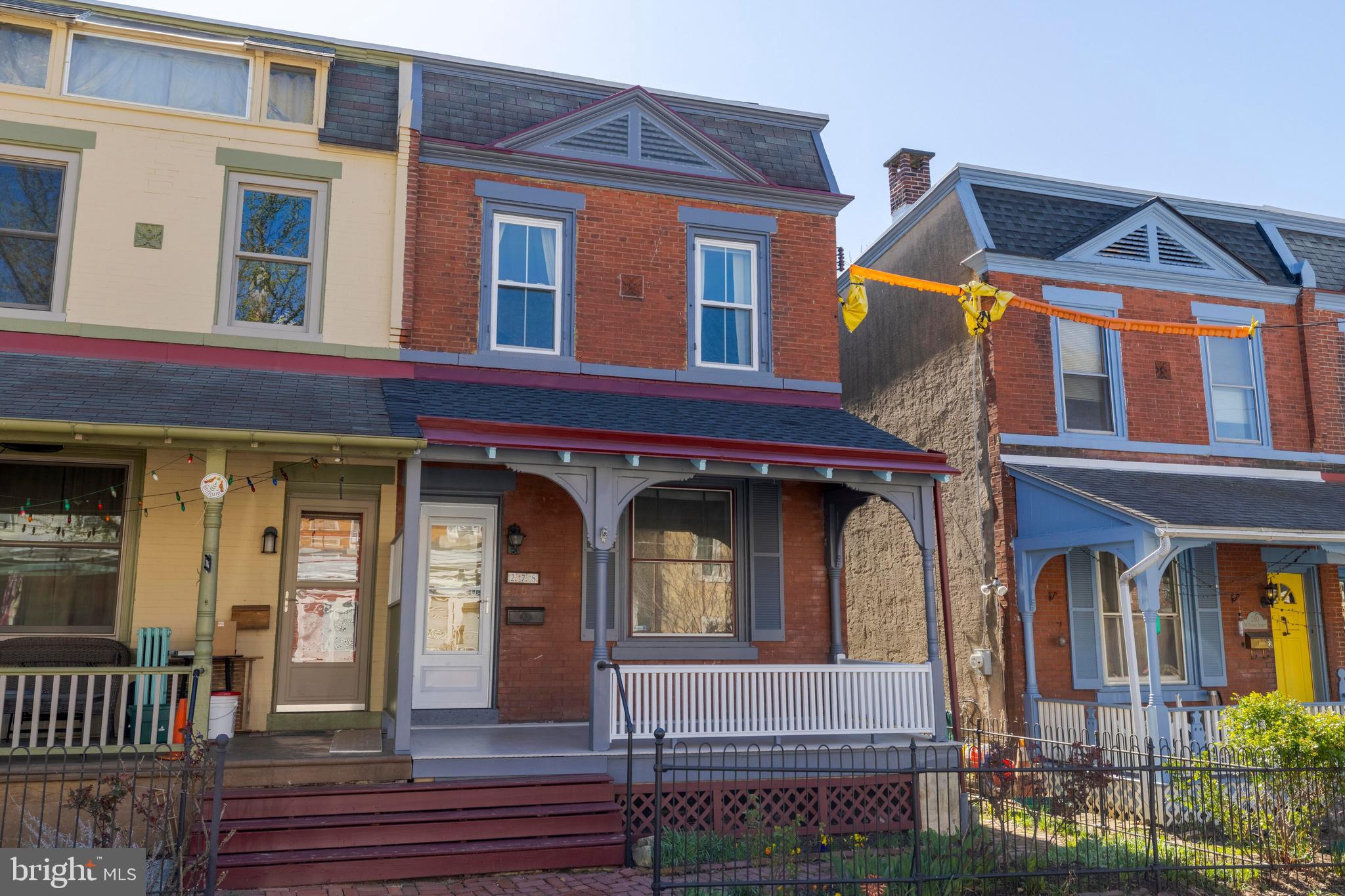Step Into History with Modern Comforts.   Built before 1895, this charming semi-detached home is a beautiful blend of timeless character and thoughtful updates, ready to welcome its next chapter—and yours. From the moment you arrive, the home enchants with its newly refreshed, gingerbread-trimmed front porch, original hairpin iron fence, classic brick walkways, and an original front door that tells stories of a bygone era.   Inside, the craftsmanship of the 19th century is immediately evident in the refinished, random-width heart of pine floors that run throughout. The living room showcases a stunning original mantle flanked by built-in bookshelves, and a striking 3-over-3 light front window with handmade glass, flooding the space with warm, natural light.   The layout feels surprisingly modern, with an open floor plan that enhances flow and connectivity. A thoughtfully designed breakfast bar peninsula opens the kitchen further into the living space, allowing light to stream in from a beautiful stained glass window. The kitchen is a chef’s delight, featuring a slate floor, granite countertops, and newer stainless steel appliances—including a dishwasher and built-in microwave.   Upstairs, you'll find three spacious bedrooms and an updated hall bathroom. The main bedroom is especially generous, with two large windows and a well-optimized closet for storage.   Out back, a large deck and yard with flowering shrubs provide the perfect setting for outdoor entertaining or quiet moments of relaxation. Recent updates include energy-efficient double-pane sash windows, a recoated roof, a new hot water heater (2021), freshly painted exterior trim, and new porch steps.   Don’t miss your chance to own a piece of history with all the comforts of today.