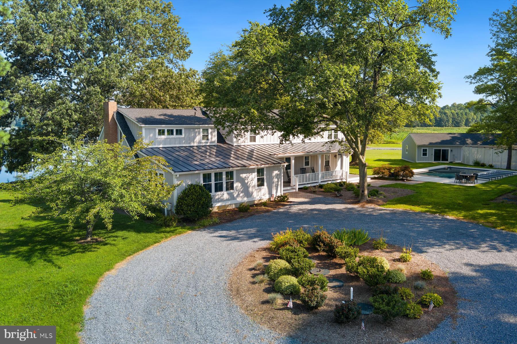 Welcome to ‘Drake’s Landing’! Beautifully sited on 20 picturesque acres on the shores of Irish Creek, this 4,602 sq. ft .completely renovated (2021) waterfront estate offers the perfect blend of casual elegance and thoughtful design. The main level welcomes with expansive water views and features a guest bedroom with ensuite bath, a cozy family room (or den/office), and a gracious living room anchored by a large brick hearth and woodburning fireplace. The gourmet kitchen is the center of the home - outfitted with upgraded appliances, a center island with breakfast bar, and additional dining space. Adjacent is a second kitchen - ideal for effortless indoor/outdoor entertaining. A formal dining room and large waterside sunroom complete the main living spaces. Upstairs, two spacious primary suites anchor each end of the home, offering privacy and comfort, with two additional guest bedrooms (one with ensuite bath) and a hall bath in between. Step outside to enjoy westerly water views from the elevated deck, or gather on the enclosed screened porch, perfect for crab feasts and sunset dining. Outdoor amenities include a charming 2BR/1.5BA guest cottage (540 sq. ft.), a new dock with two slips, stunning waterside pool,  waterside firepit, and barrel sauna. A 3-bay equipment garage is connected to an enclosed game room and workshop - creating a complete retreat for relaxation, recreation, and unforgettable waterfront living. The property with its acreage is also great for hunting. This is Eastern Shore living at its best – spacious, serene, and set up for year-round enjoyment. *Furnishings may be available for sale.