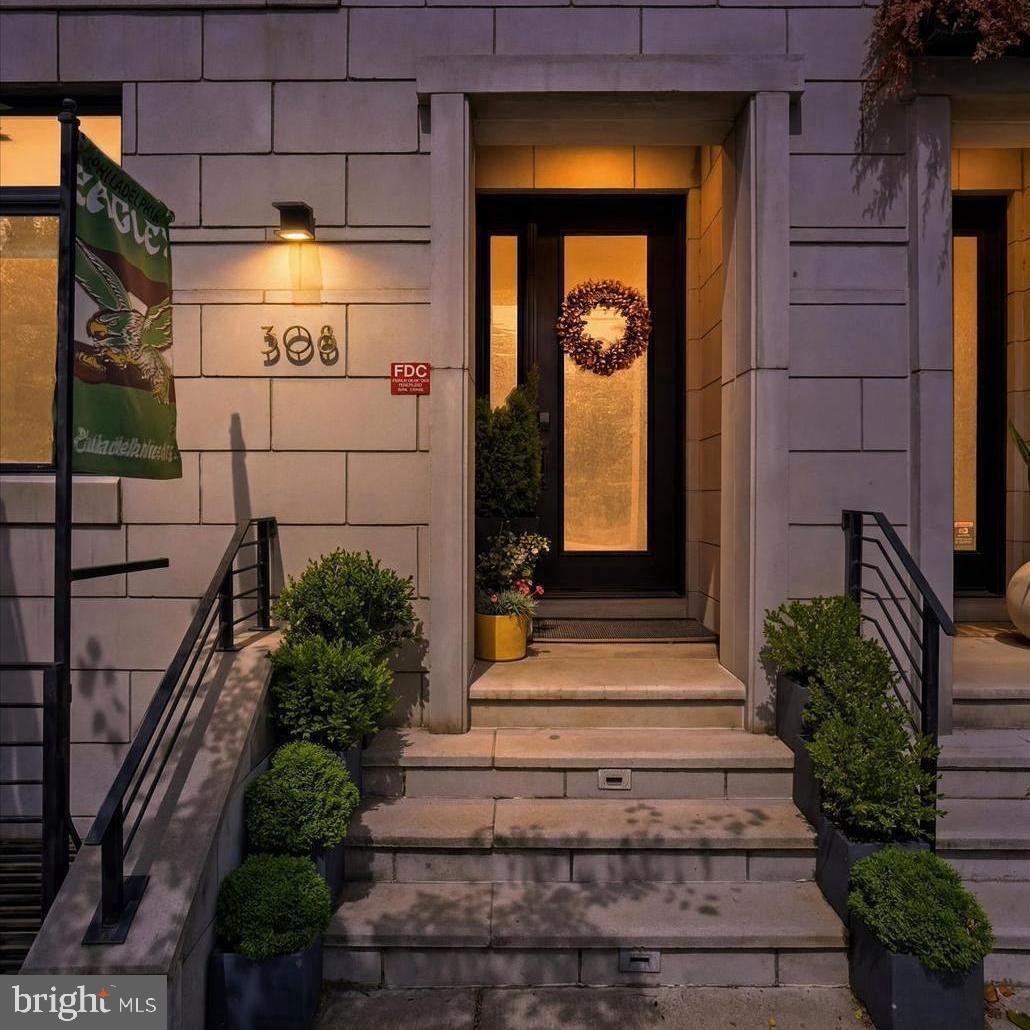 Situated in the heart of Philadelphia's historic Old City, 308 N. 2nd St redefines luxury city living, offering an exceptional balance of generous living spaces, refined design, and unmatched walkability. This meticulously maintained residence features 4 bedrooms, an optional 5th bedroom, 3 full bathrooms, 2 powder rooms, multiple private outdoor spaces, and the rare luxury of a gated easement to two-car garage parking.

A striking brick façade and recessed entrance create an impressive first impression, while rich hardwood floors, custom millwork, and a dramatic iron staircase with 300 year old reclaimed wood establish the home's timeless character. The entry level offers custom built-in storage, a powder room, generous closet space, and direct access to the attached garage making everyday arrivals and departures effortless.

Designed for entertaining and comfortable daily living, the second floor showcases soaring ceilings, oversized windows, and a floor-to-ceiling fireplace anchoring expansive living and dining spaces. Sliding glass doors open to a private terrace, while a wet bar and powder room complement the space. The renovated chef's kitchen features custom cabinetry, waterfall quartzite countertops, an oversized island, designer lighting, and premium Gaggenau appliances.

The third floor is highlighted by a luxurious primary suite with dual walk-in closets and a spa-inspired bath featuring heated floors, a floating double vanity, soaking tub, and glass-enclosed multi-jet rainfall shower. A spacious second bedroom offers flexibility as a guest room, nursery, or home office.

The fourth floor includes two additional bedrooms, a Jack-and-Jill bathroom, conveniently located laundry, and a wet bar serving the rooftop terrace above.

One of the home's defining features, the rooftop terrace is centered around an outdoor fireplace and framed by sweeping views of the Benjamin Franklin Bridge and Philadelphia skyline, creating an unforgettable setting for entertaining or relaxing above the city.

The finished lower level offers exceptional flexibility as a recreation room, media room, fitness studio, guest suite, or optional fifth bedroom with a full bathroom. Additional highlights include hardwired speakers, heated bathroom floors, multi-zone central air conditioning, and a lighting control system.

Beyond the front door, Old City becomes part of everyday life. Wander cobblestone streets lined with historic architecture, art galleries, boutiques, neighborhood cafés, and celebrated restaurants including Fork, Tuna Bar, Zahav, Olea, and local favorites. Explore Race Street & Cherry Street Piers, Penn's Landing, Spruce Street Harbor Park, and more, all just moments away.

Directly across the street, Redbud Park stretches to Wood Street, creating a beautifully landscaped neighborhood retreat with an expansive community investment including new seating, planters, gathering spaces, and open green areas. The forthcoming Little City Montessori campus further enhances Old City's appeal for families seeking an exceptional urban lifestyle.

With a Walk Score of 96 and convenient access to public transportation, I-95, and I-676, this location offers one of Philadelphia's most vibrant and walkable lifestyles.

HOA dues include alarm and fire system monitoring, snow removal, tree trimming, window washing, gate maintenance, and insurance. Tax abatement remains in place through 2029, according to public records.

An exceptional opportunity to own one of Old City's premier luxury residences, where sophisticated design, remarkable outdoor living, secure parking, and the timeless character of Old City come together in one extraordinary home.