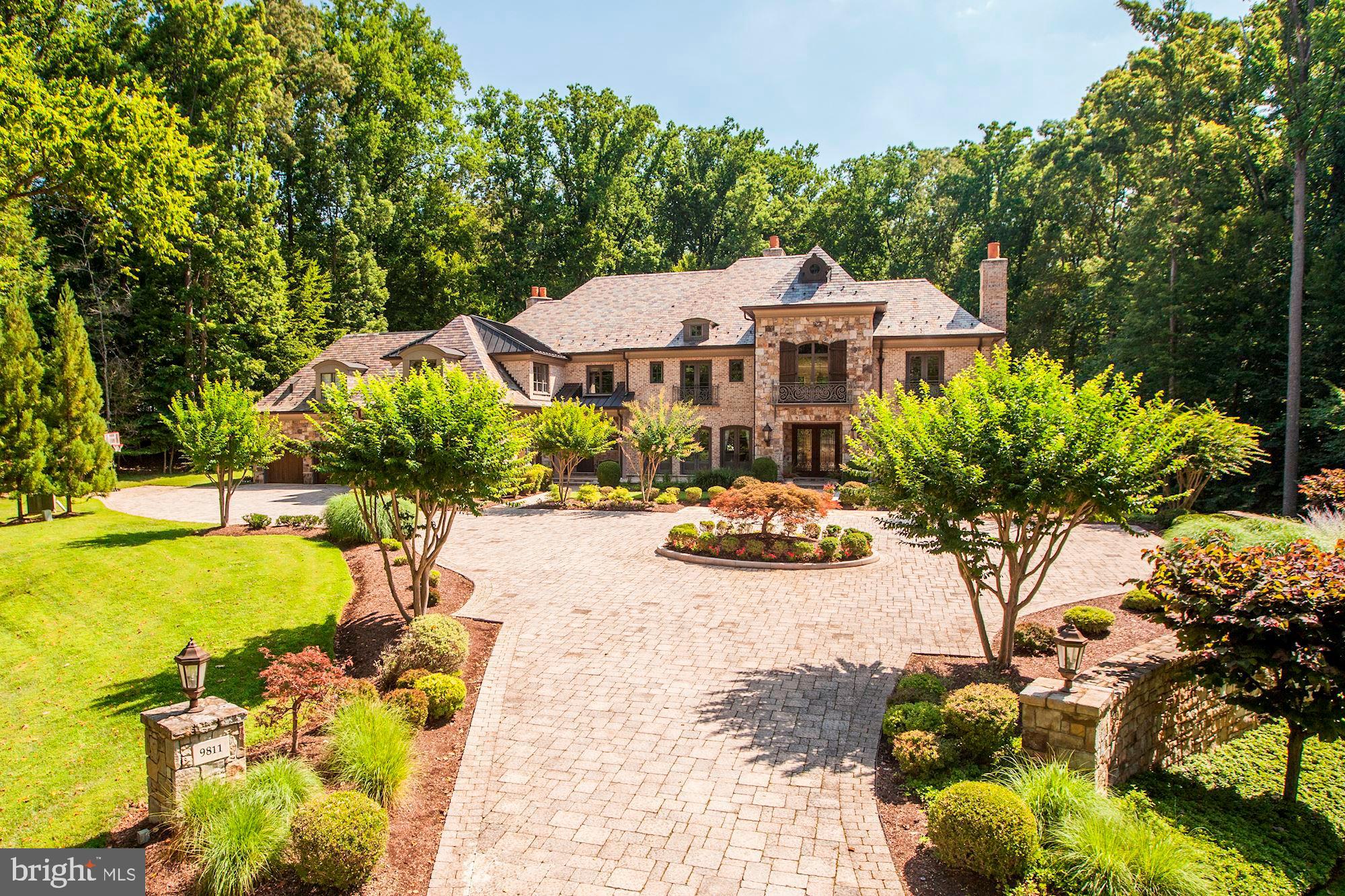 Incredible custom home offers nearly 14,000 SF of luxury living space on 2 private acres backing to serene parkland! Six Bedroom Suites each have their own Bathrooms, including Master Steam Shower, Bubble Tub, w/ His & Her Walk-In Closets and Water Closets, convenient laundry. Dramatic Two-Story Foyer and Living Room offer tons of natural light and gorgeous spiral staircase to the upper level. Top-of-the-Line Family Kitchen, Catering Kitchen, and Lower Level Bar - each with high-end Wolf/Sub-Zero appliances. LL Billiards Room, Wine Cellar, and more. Fabulous Rear Garden w/ Outdoor Kitchen. 4-Car Garage.