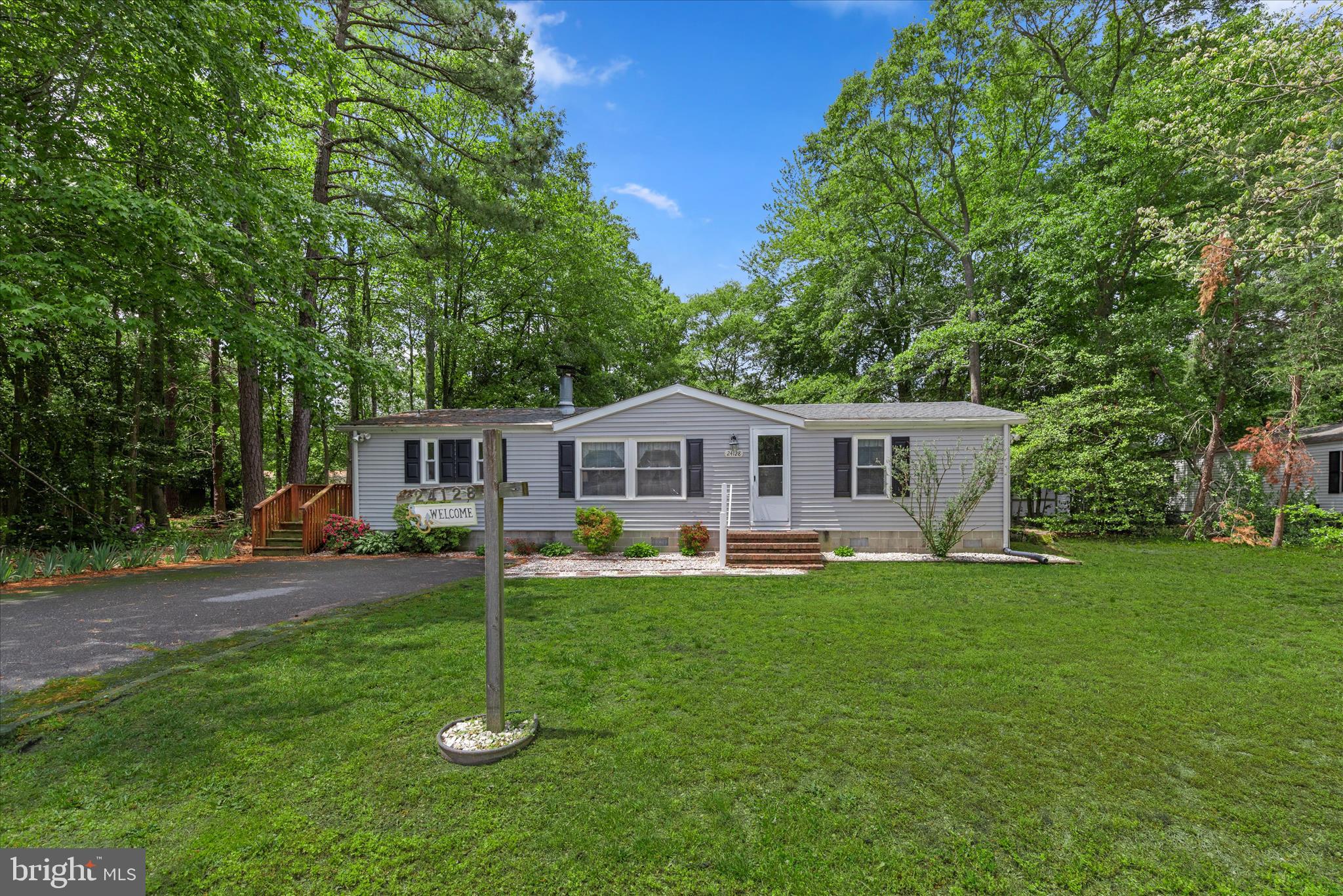 Welcome to 24128 Celtic Street, a charming 3-bedroom, 2-bath Class C ranch home tucked within a peaceful community surrounded by mature trees and picturesque farmland. Offering a quiet setting with a sense of retreat, this home is ideally positioned in Avalon Park with convenient access to Harbeson, Lewes, Georgetown, and Millsboro, while Delaware’s beautiful beaches, shopping, dining, and everyday conveniences remain just a short drive away.

Enjoy the added value of no ground rent-you own the land, along with a low annual HOA fee. The home is being sold partially furnished, making your transition even easier.

Inside, the inviting living room features vaulted ceilings and a cozy fireplace, creating a warm and welcoming atmosphere. The adjoining dining area flows seamlessly into the spacious country kitchen, offering a functional layout for both everyday living and entertaining.

The primary suite includes a private attached updated bath, while two additional bedrooms and a hall bath provide comfortable accommodations for family and guests. A dedicated laundry room with cabinetry adds convenience and additional storage space.

One of the home's standout features is the enclosed three-season porch, an ideal place to enjoy your morning coffee, unwind in the evenings, or take in the peaceful surroundings throughout much of the year. Outside, a generously sized backyard provides room to relax, garden, or play, and a large storage shed offers ample space for tools and equipment.

For added peace of mind, the roof was replaced in 2025. This is a wonderful opportunity to enjoy comfortable living in a tranquil setting with the benefit of owning the land beneath you.