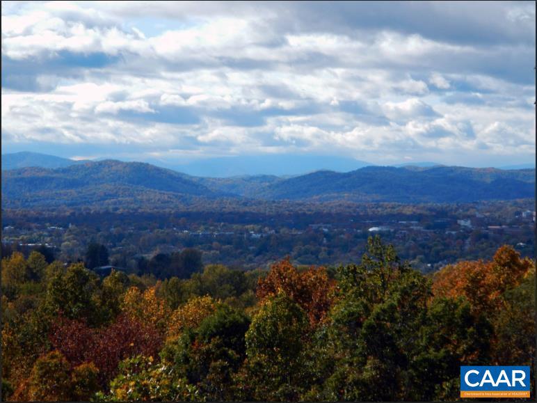 Awe-inspiring views of the Blue Ridge Mountains as far as Wintergreen, from this 5 bedroom, 3.5 bath home. Custom designed and built by Ashcroft's premier builder, who's attention to detail is astounding. Sparkling City lights in the valley below make for a magical view upon sunset. Located on a private 2.3 acre treed lot surrounded by nature. Head out on the walking trails that generate just below (and above) this breathtaking property and hike for miles through wooded areas past creeks, streams and ponds. Ashcroft is one of the most coveted neighborhoods in Albemarle County due to the proximity to downtown Charlottesville, UVA, M. Jefferson and Rte 64. Amenity rich subdivision with a soccer field, tennis, pickle ball and volleyball. As you enter the foyer you are greeted by a custom handmade stairway. The Great room boasts accent beams and custom-designed wood burning fireplace. Open concept floor plan allows the home's many windows to drench the rooms with natural light. Artfully designed kitchen with granite counters and tile backsplash. Nothing cookie-cutter about this home with its many special accents, one of which includes cherry french doors with stained glass trim leading to an office/dining room.,Cherry Cabinets,Fireplace in Family Room,Fireplace in Great Room