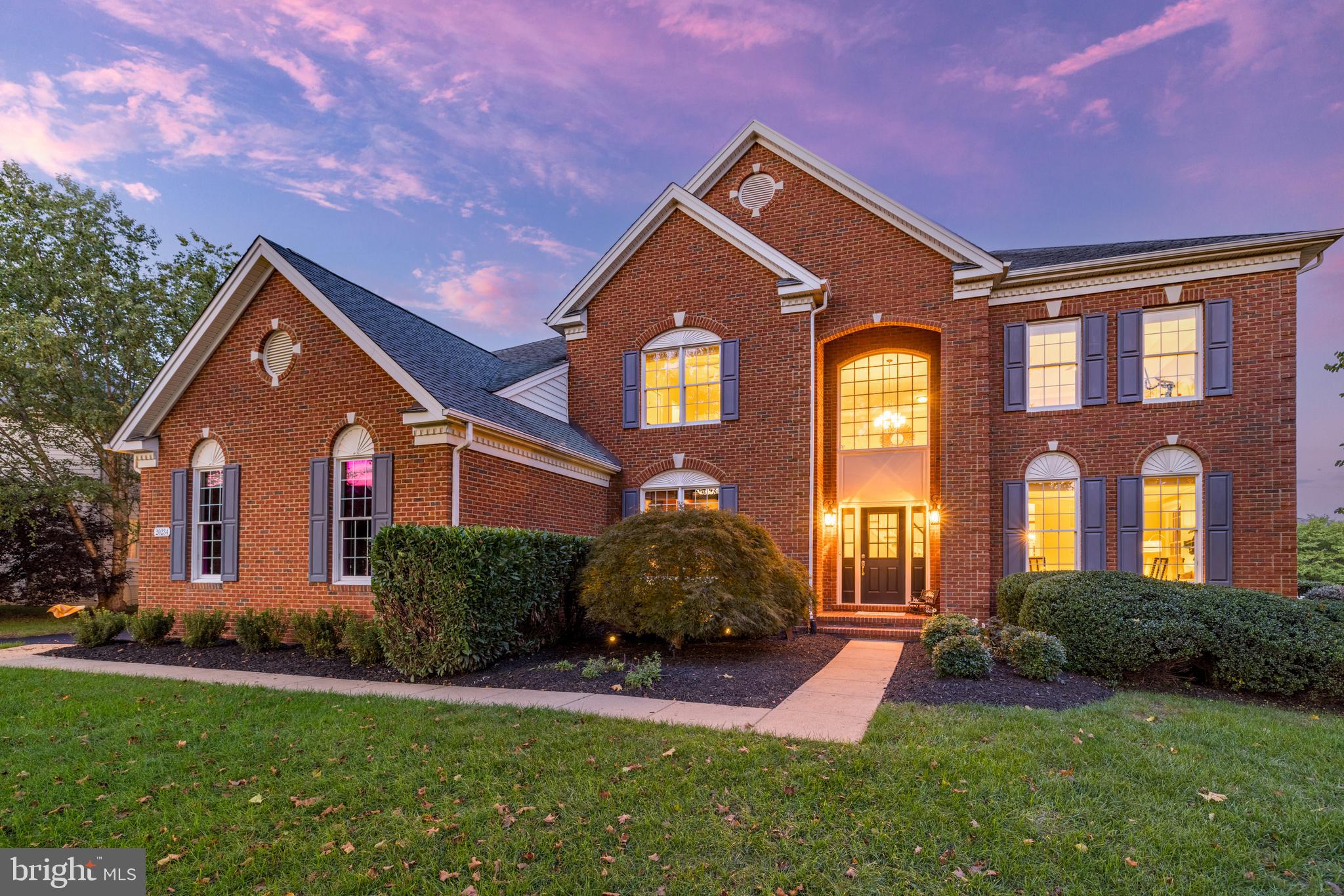 Located in the prestigious community of Belmont Country Club, this stunning Estate Series Somerset model home captures an unparalleled blend of luxury, comfort, and style. Enviably located on a private cul-de-sac lot backing to mature trees, the property boasts extensive updates estimated at $500K, including a renovated kitchen and bathrooms, refinished hardwood floors, and a beautiful new outdoor living space and pool. Enter into the formal, double-height foyer, greeted by rich finishes, elegant moldings, and impressive volumes of light and space that continue throughout the interior. Formal living and dining rooms offer flexible space for your gatherings and day-to-day relaxation. The completely renovated and reimagined gourmet kitchen pairs chic quartz countertops with high-end cabinetry and stainless-steel appliances, a dream for the discerning home chef. Enjoy casual meals at the breakfast bar island, adjacent sunroom, and eat-in dining area of this flowing open-concept, ideal for entertaining, which seamlessly joins the family room with soaring coffered ceilings, fireplace, and a wall of windows pouring with natural sunlight. Continue your entertaining outside on the expansive deck overlooking your upgraded backyard pool oasis. Dip in the water, relax on the travertine patio, and gather round the fire pit, surrounded in the private embrace of trees and a new all-weather fence, in this resort-inspired outdoor retreat. The home's main level also includes a private home office with built-ins, a well-placed powder room, and a spacious remodeled mudroom with laundry and access to the 3-car, side-load garage. After a day of entertaining, escape to your luxurious primary suite with a tall tray ceiling and treetop views. The spa-inspired primary bath is remodeled to perfection, with a freestanding tub, large shower, double Shaker vanities, and two walk-in closets. Three additional upstairs bedrooms include a junior suite with private en suite bath, and two bedrooms with ample closet space sharing an updated jack-and-jill bathroom with contemporary wide-format tile and double-sink vanity. Carpets have been updated on the main and upper levels. The lower level provides even more versatile space to spread out and entertain. The walk-up rec room boasts ample area for games and media, remodeled to include a deluxe bar with beverage fridge, wine fridge, and a Tileshop backsplash. A large bedroom and full bathroom on this level create an excellent guest suite, while the bonus room is perfect for a home gym, play area, or second office. Unfinished space allows for storage or customizing to your personal needs. This beautiful, spacious, and well-kept home is close to highly rated schools and all the amenities of Belmont Country Club, including community pools, tennis, basketball, volleyball, playgrounds, trails, and more. Belmont Country Club is an award-winning community designed around an Arnold Palmer 18-hole golf course and a 35,000 sq ft clubhouse, with architecture inspired by historical Virginia designs. Residents enjoy easy access to multiple nearby shopping centers, diverse dining and recreation, and all the best that northern VA has to offer. Offering style, location, and the ultimate comfort and amenities, this exceptional property unlocks a sought-after lifestyle. Welcome home!