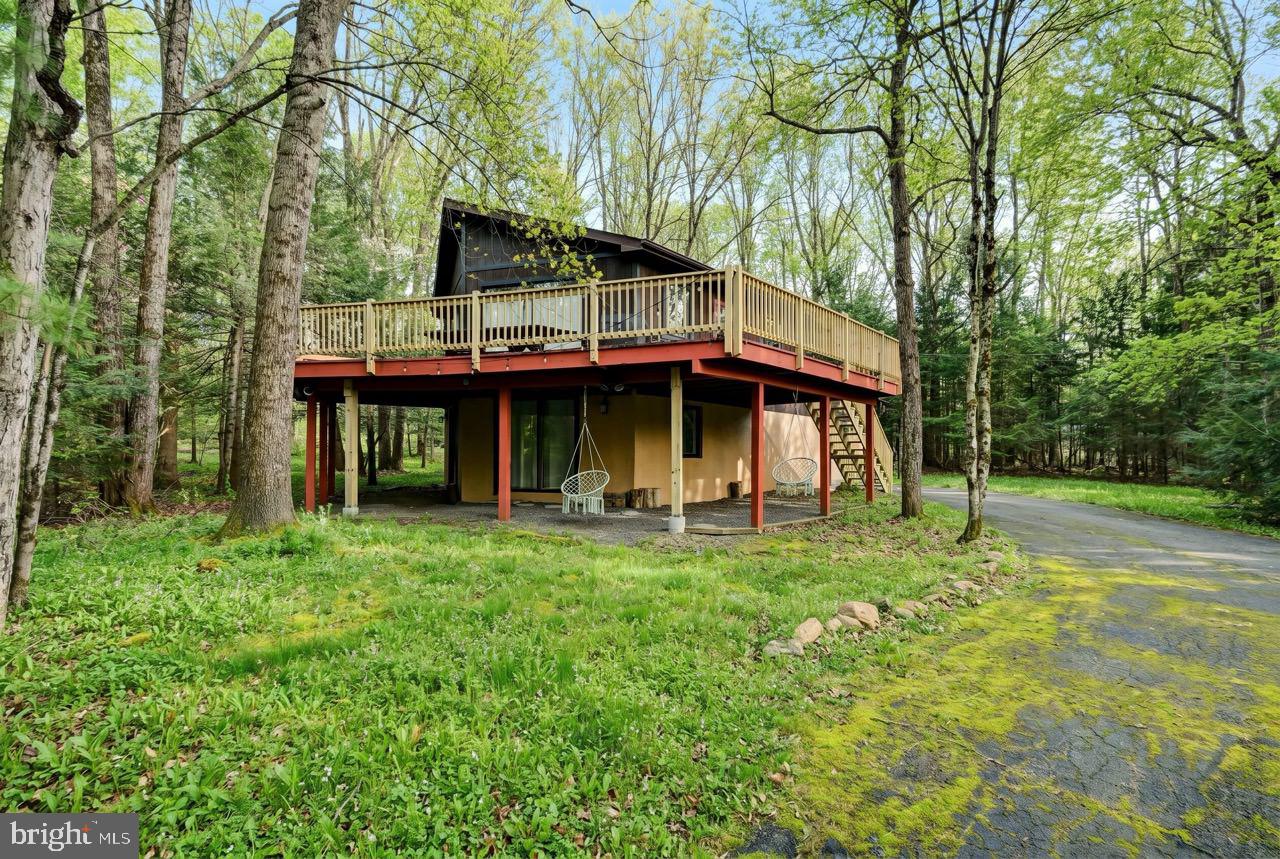 Make an offer and make it your own, ASK YOUR AGENT FOR ALL OF THE DETAILS! The possibilities are endless at 56 Dryden Drive! Located on a quiet, low-traffic street, this fully furnished raised ranch Chalet 4BR/2BA home sits on an oversized parcel with the included adjacent lot on Dryden Drive, offering over 1 acre of land for added privacy and future potential. Designed with short-term rental use in mind, the home offers flexible living space across two levels. The upper level features a full kitchen, coffee bar, 3 bedrooms, 1 full bath, and a cozy wood-burning fireplace. The lower level is set up as a recreation/game area along with an additional bedroom and a second full bath, ideal for maximizing enjoyment. Attached 1-car garage for additional storage or to park your golf cart! Recent updates include a deck brought up to township code. Property is being sold fully furnished, making for an easy, immediate STR launch or seamless transition for a second home buyer. Prime location just minutes to I-80 and the PA Turnpike, with close proximity to Jim Thorpe, Lake Harmony, and area ski resorts. Towamensing Trails amenities include a 190-acre lake with beach access, outdoor pool, tennis courts, playground, and private restaurant. Property is served by a 3-bedroom septic system. Buyer always must perform due diligence regarding STR use with township and HOA.
