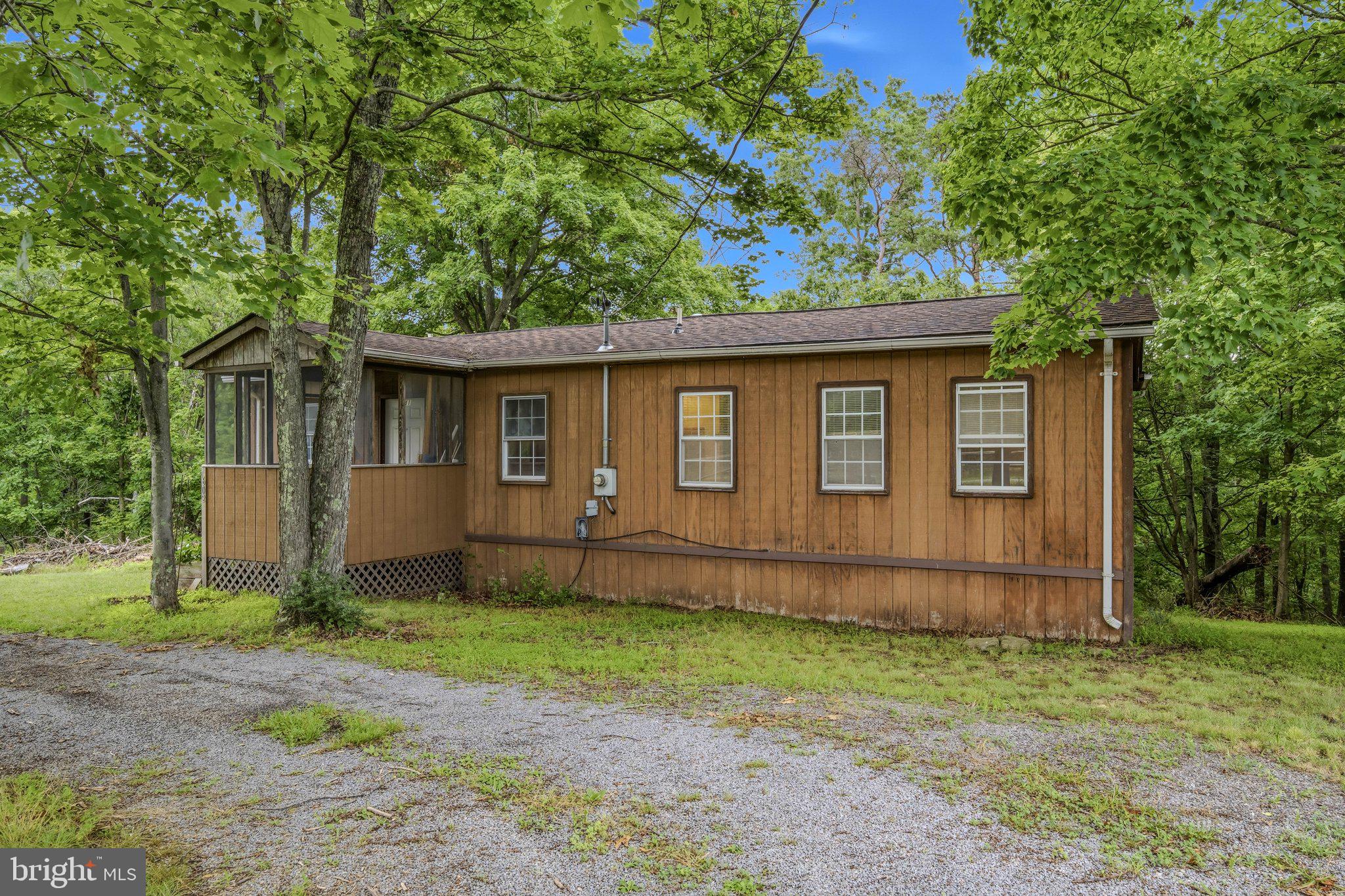 Escape to your own mountain retreat with this charming 2-bedroom, 2-bath cabin nestled on 4.3 acres across two lots. Enjoy peaceful mornings on the screened porch, relaxing afternoons on the open deck, and plenty of room to expand, garden, or simply soak in nature. Enjoy Sleepy Creek access from the community common lot that is off Highview Ln.
Located just minutes from Cacapon State Park, you’ll have easy access to a sandy beach, the stunning new lodge, championship golf course, horseback riding, and miles of scenic biking and hiking trails.
Whether you’re seeking a weekend getaway or a full-time haven, this property offers privacy, recreation, and the true West Virginia mountain experience.