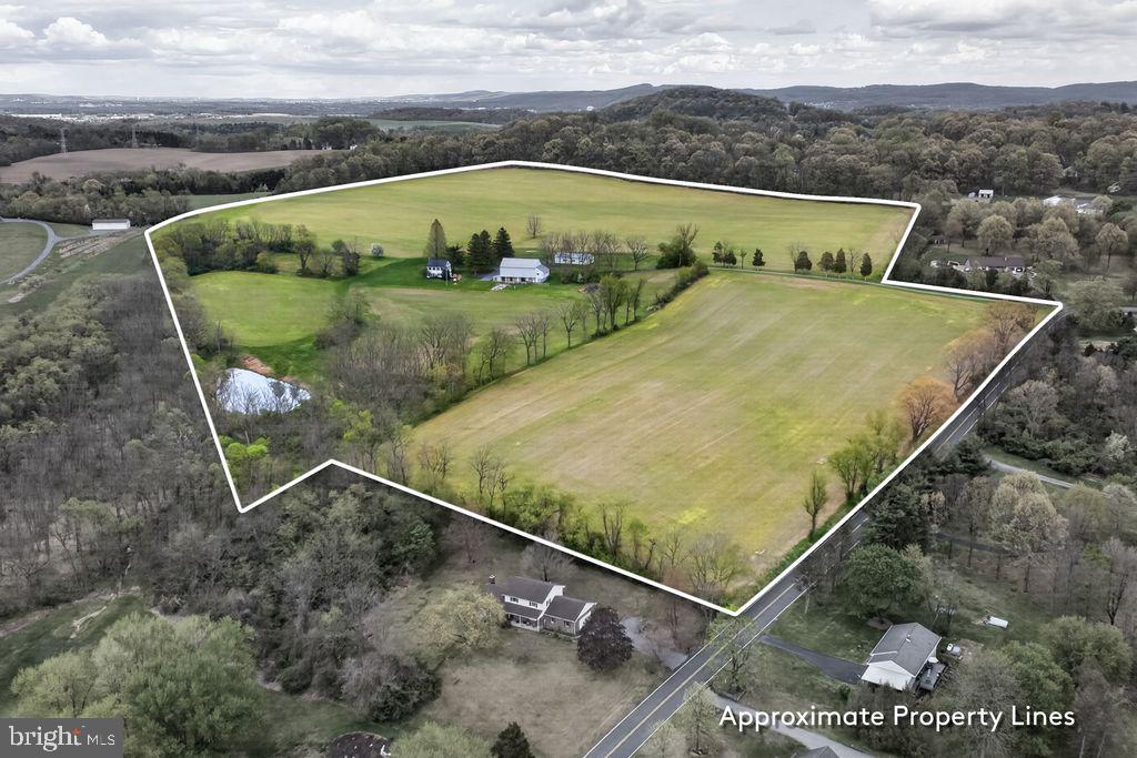Tucked away on 51.15-acres, this Berks County farm features a spring-fed pond and approximately 40 tillable acres. The long, tree-lined macadam driveway adds privacy and welcomes you to this peaceful countryside retreat The well-kept 2.5-story farmhouse offers a custom kitchen with stainless steel appliances and 1,922 square feet of living space, including 3 bedrooms, 1.5 baths, loft, a spacious living room with a marble fireplace, formal dining room, and laundry area. Additional upgrades include Andersen replacement windows, mini-split A/C units, and a 22KW Generac generator.

Outbuildings include a root cellar, a 36' x 73' bank barn with 3 stalls, stable area, and drive-in second floor, plus a 30' x 60' insulated Morton Buildings structure equipped with separate electric service, water, forced-air heat, and a phase converter—ideal for a home business or workshop.

Nature lovers and hunters will appreciate the abundant wildlife. The pond offers year-round recreation and irrigation potential. Conveniently located near Blue Marsh Lake, State Game Lands 280, and with easy access to Routes 183, 222, and 78, you’re just a short drive to Wyomissing, Reading, and beyond.

Bring your fresh vision to make this working farm your own. It is an exceptional opportunity to live, work, and raise a family on a beautiful farm property. This land is ready its' new owners to continue a legacy of land stewardship.