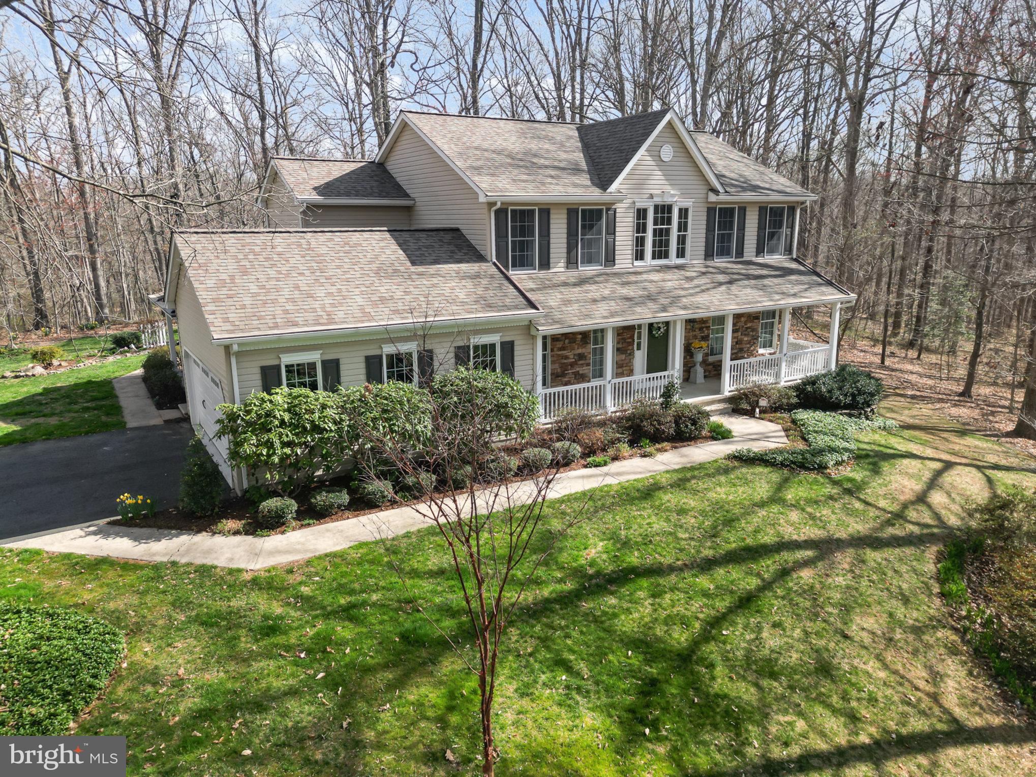 Welcome to your private retreat in the desirable community of St. Anne! This beautiful custom-built 4-bedroom, 2.5-bath colonial is nestled on just over 11 acres of wooded, picturesque, park-like serenity. The beautifully landscaped property boasts extensive perennial gardens, a naturalized fish pond, landscape lighting, and a natural stone patio, creating an enchanting outdoor oasis. Enjoy peaceful mornings or evening gatherings on the maintenance-free 17’ x 18’ deck or relax on the charming covered front and side porches while taking in the tranquil natural beauty.  A charming 16’ x 10’ shed offers versatile use as storage, a potting shed, or even a playhouse.   
Step inside to a dramatic two-story foyer that sets the tone for this elegant home. The spacious living room features french doors leading to the inviting family room, which boasts built in bookcases and is highlighted by a stunning stacked stone fireplace—perfect for cozy gatherings. The gourmet kitchen features a walk-in storage pantry and butler’s pantry, seamlessly flowing into the spacious dining room, ideal for hosting memorable dinners.
A huge main level office/hobby/play room with a separate side entrance with covered porch offers endless possibilities—perfect for remote work, creative pursuits, or even a private guest space. The spacious primary suite is a true retreat, featuring a recently renovated spa-like bath with dual sinks, a free-standing soaking tub, and a separate shower for ultimate relaxation.
With spacious living areas, a thoughtfully designed floor plan, and captivating surroundings from every window, this exceptional property offers the perfect blend of luxury and tranquility.   And just when you think it can't get any better, take a stroll to the community's common area offering walking trails and access to Deer Creek!   This truly is a rare opportunity to own a slice of paradise while still being conveniently close to schools, restaurants, shopping, and parks—don’t miss your chance to make this dream home yours!
Updates:  Roof w/transferable warranty 2018, Composite Deck and Railings 2018,  50 gallon propane HWH 2017,  Well Pump 2016, Furnace 2015