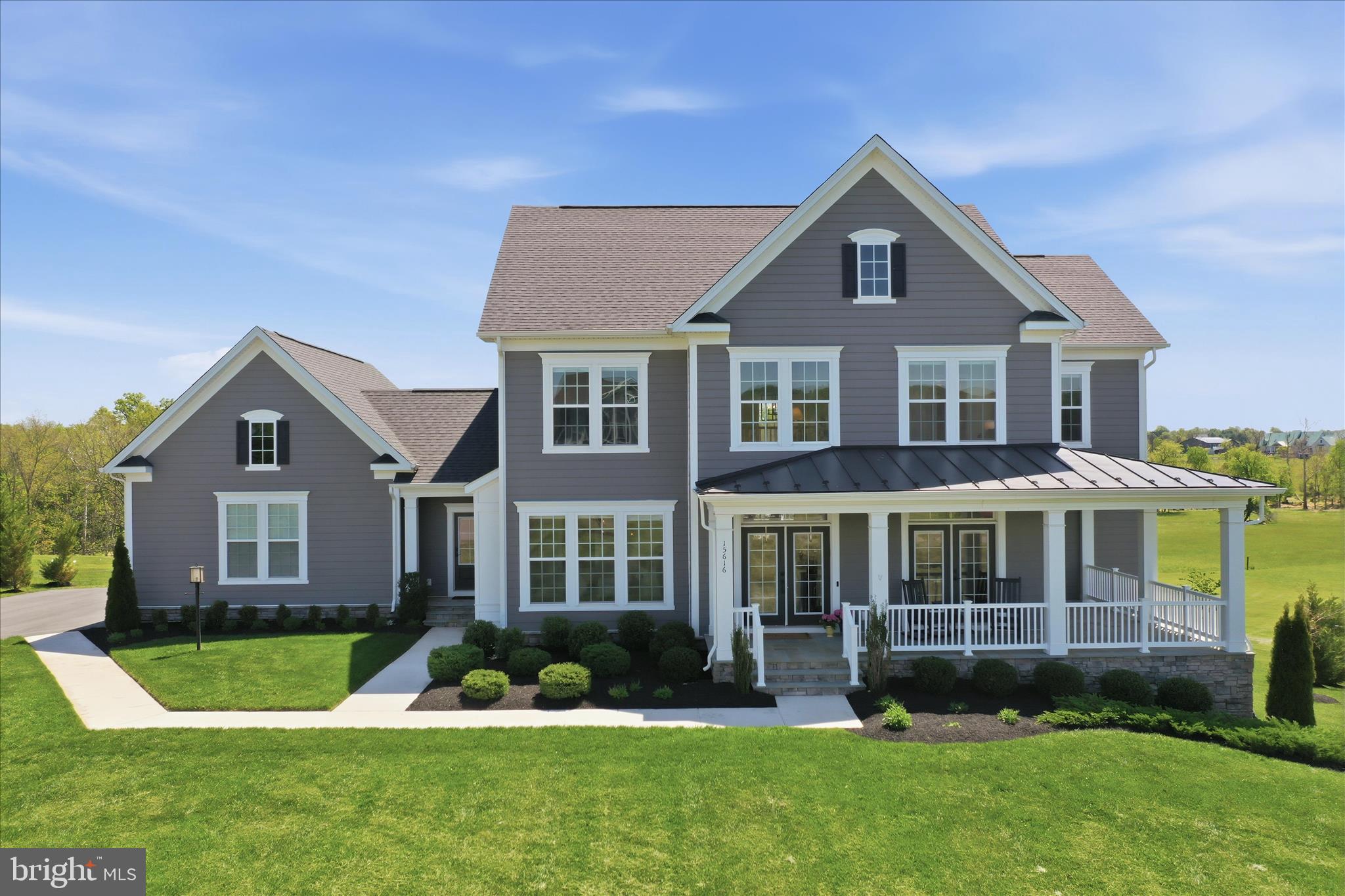 Welcome to 15616 Pigott Court, modern luxury nestled within the prestigious Miller’s Reserve community of Hillsboro. This prime location places you at the heart of Loudoun County’s renowned wine country, the Appalachian Trail, and the charming shops and local eateries of nearby Purcellville, providing the perfect blend of small-town warmth and upscale convenience.     
Built in 2022 and excellently maintained, this Evergreene-built home offers 3 levels of finished living space on just under 2 acres of pristine land. The home’s exterior is wrapped in durable HardiePlank siding, while a welcoming covered front porch with elegant flagstone flooring sets the tone for the sophisticated design found within.
The main level is designed for both grand entertaining and effortless daily living, featuring gleaming hardwood floors and a versatile layout. Culinary enthusiasts will appreciate the gourmet kitchen with its dedicated Butler’s pantry, which flows seamlessly into both the casual dining area and the formal dining room. For those working from home, the private office provides a quiet retreat, while the highly sought-after main-floor guest or au pair suite ensures comfort and privacy for visitors.
Upstairs, the luxury continues with the spacious owner’s suite. Each additional bedroom includes its own private bathroom. The home’s thoughtful layout includes a dedicated laundry area on each floor, including the lower walk-out level, where you will find an additional living area. This 1-bedroom plus den suite features an open floor plan with kitchen, dining, and living area opening to its own private patio.
Open and rural views define this unique property, combining the peace of a pastoral setting with the amenities of a high-end estate. This home is a rare opportunity to experience the very best of Virginia living.