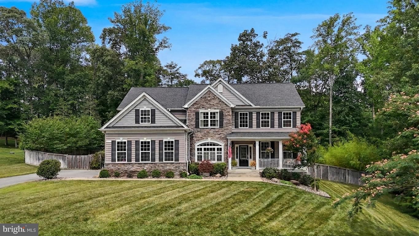 Welcome to this beautifully upgraded Quality Built Homes Aberdeen model, where quality in construction and energy star features, set this home apart. The stone front elevation, professional landscaping with rock beds, fenced backyard, and mature bamboo create incredible curb appeal and added privacy to the 1 acre lot. Inside, you'll be greeted by a 2 story foyer, engineered hardwood flooring throughout the main level, a bright open floor plan, and a stunning kitchen featuring granite countertops, cream  soft close cabinetry, stainless steel appliances, and a spacious living room that fills the home with a plethora of natural light. Upstairs offers 4 generously sized bedrooms, including a spacious owner's suite with tray ceilings. This room is different from your usually colonial as this has a private deck overlooking your backyard, a glass walk-in shower, soaking tub, dual vanities, and a large walk-in closet. Convenient upstairs laundry room and a linen closet adds everyday functionality. The finished basement boasts 9-foot ceilings, a large recreation area, and a dedicated storage room complete with built-in shelving. Additional upgrades include a dual-zone HVAC system with UV air treatment, a water softener, tankless water heater, improved well pump for increased water pressure, built-in garage shelving, custom window treatments, plantation shutters on the front of the home, an in-ground sprinkler system, and three separate decks providing plenty of space to relax or entertain. This is a home where every upgrade has already been done for you.