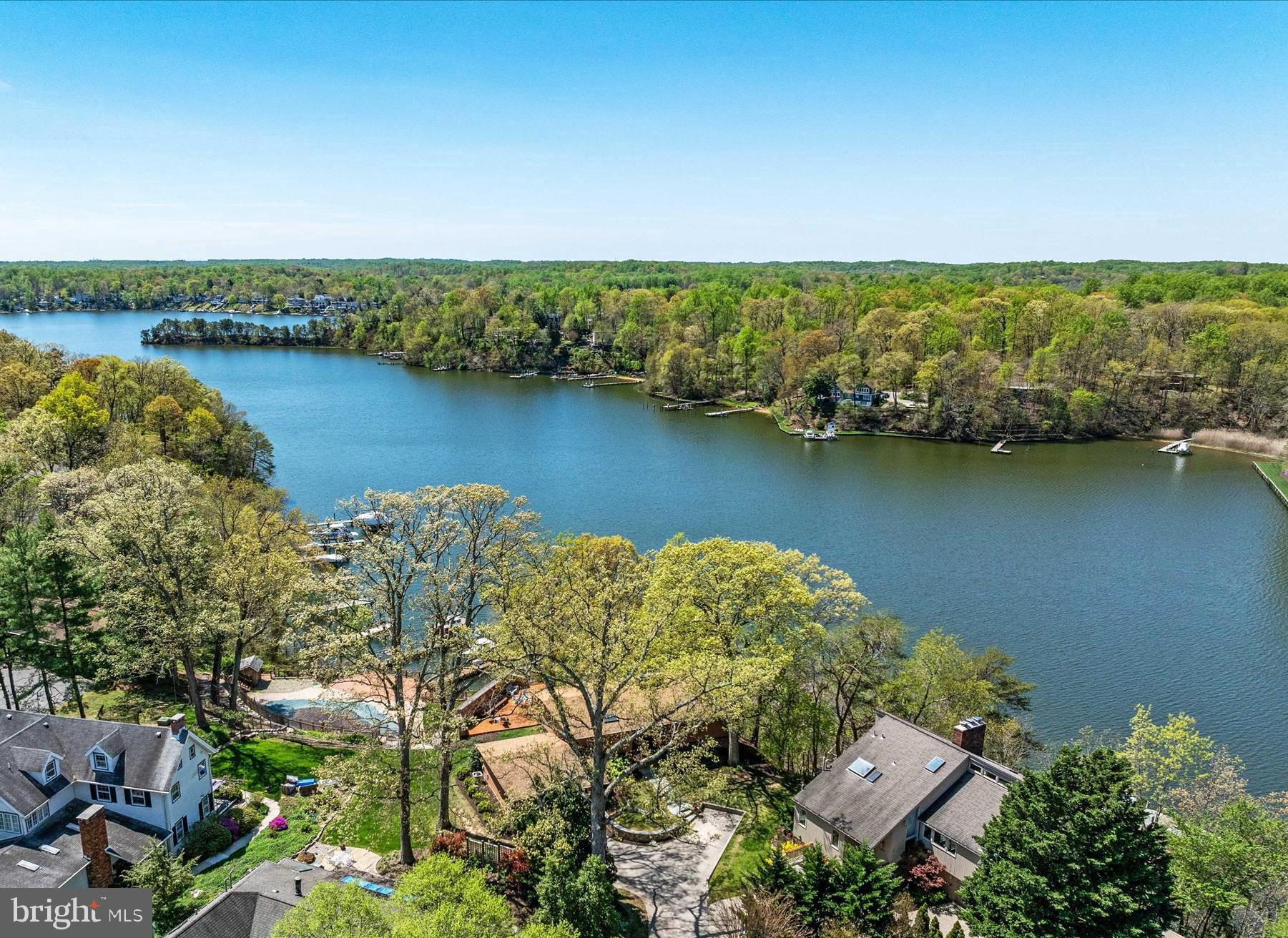 Bright, airy waterfront deck home in Broadview Estates with sweeping western views across Broad Creek. The property includes a tram, private pier, 2 deepwater boat slips (40 feet and 50 feet), water, power, and small boat lift.  The home features a main-level primary bedroom with ample closet space and ensuite bath; open kitchen, living, and dining area with a large brick wood-burning fireplace; vaulted cedar ceilings; and walls of windows to bring the outside in.  The western-facing deck is ideal for dining, entertaining, and enjoying river views.  The lower-level offers two additional bedrooms, family room with modern wood-burning stove, second full bath, laundry and utility room, and an enormous custom walk-in closet. The almost 600 square foot attached 2-car garage includes plenty of additional storage and work space.  This home has public water, sewer, and gas. Beautifully maintained; recent improvements include LVP floors on main level (2024), carpets in lower level bedrooms (2024), heat pump (2023), and GE Refrigerator (2023). This home has everything you could want:  a deepwater pier, amazing sunset water views, main-floor primary bedroom, and over-sized attached garage. The driveway is shared with 373 and 375 Broadview Ln. This popular waterfront neighborhood has a community pier, boat launch area, walking paths, and sidewalks - all within easy access to DC, Baltimore, and the Eastern Shore. Contact listing agent for private tour.