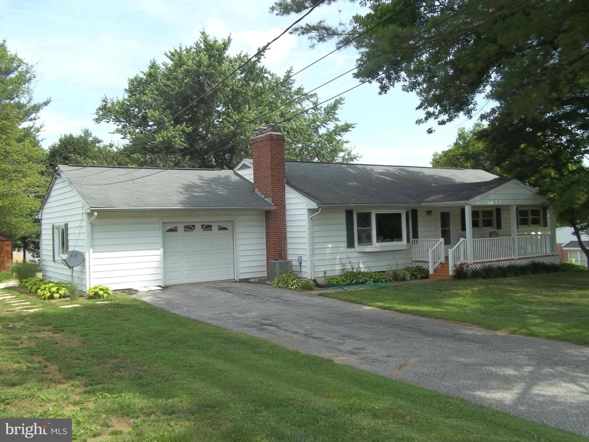 Amenities Galore - featuring gleaming wood floors, main level family room off extra large kitchen and dining room, main level rec or storage  room, 3 generous bedrooms, two full baths, living room fireplace, large attached garage with shop, two detached sheds, one with electricity, shady front porch, sunny rear deck and  plenty of back yard on this lovely 3/4 acre lot.
