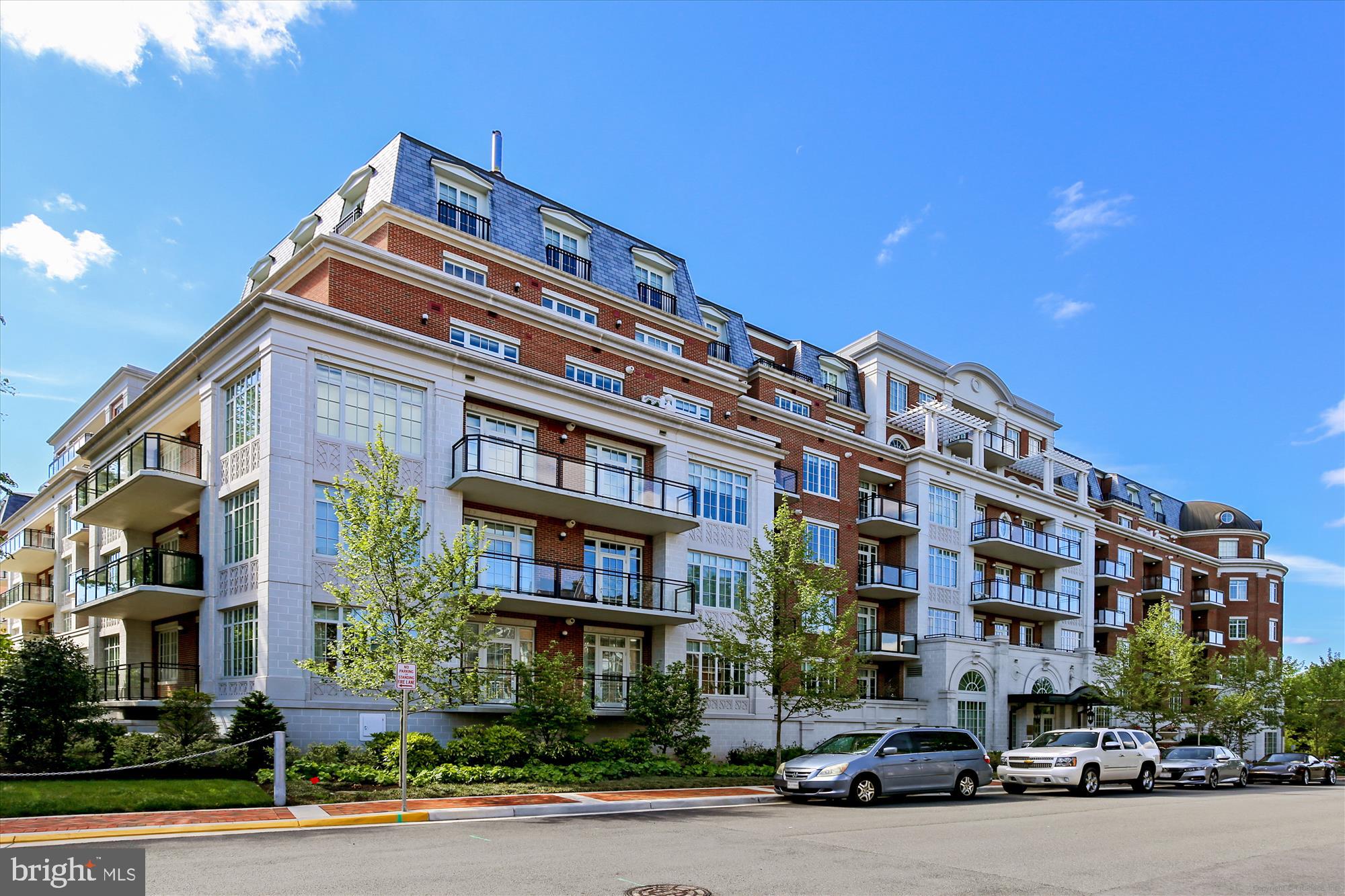 Welcome to The Signet! A luxury residence with exquisite detail unlike any other in beautiful McLean, VA. This stunning, 2,136 sq ft unit features a gourmet kitchen, top of the line appliances, upgraded lighting fixtures, and a massive center island... a chef's delight! Automatic Hunter Douglas shades, alarm system and fitted closets. The open concept living/dining room and kitchen gives you access to the largest ground-level terrace (500 sq. ') in the building. A diamond in the ruff at The Signet, with two generously sized bedrooms and a den/home office, you have all the space you need for comfortable living, at-home working, and entertaining. Gleaming hardwood floors and 9' ceilings throughout. In the primary suite, find a refined and elegant primary bath and fitted walk-in closet. The Signet features a ton of amenities, including a grand lobby entrance with a full service concierge, a clubroom, fitness center, sauna, steam room, massage room, fitness trail, a pet spa, and more! The Signet is home to an impeccably landscaped courtyard with 4 lounge areas offering tables, a fire pit area w/ seating, a Trellis covered outdoor bar and a grilling area. Unit includes 2 assigned garage parking spaces: #314, #316.  Call lister about the availability of 2 storage units.