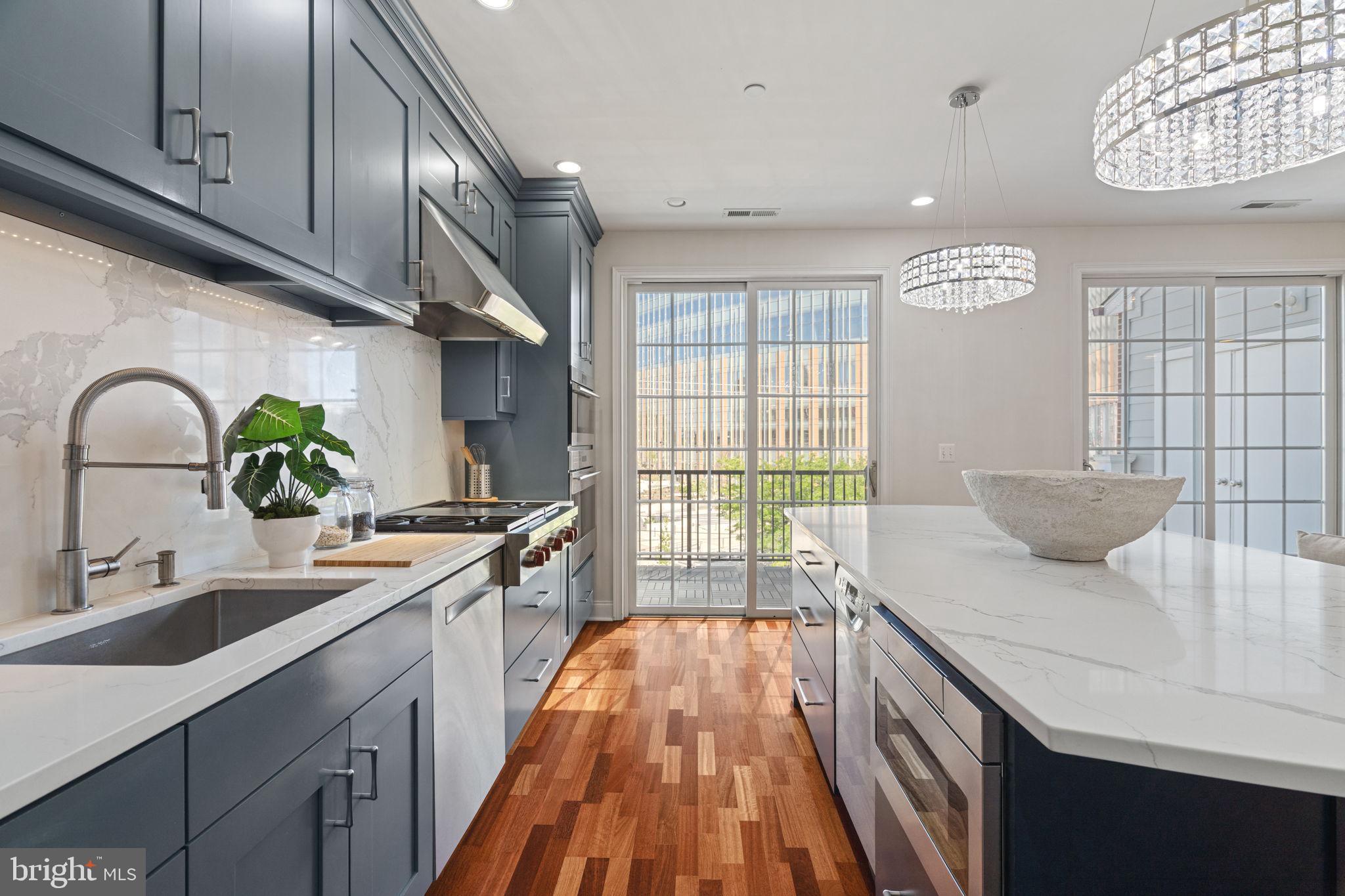 Introducing a magnificent townhome that encapsulates luxury living in the heart of Philadelphia!  Ideally located in a prized, gated enclave just south of Fitler Square, and only steps to University City, this Naval Square home is exactly what you have been waiting for! 406 Regatta Drive is an exquisite bi-level townhome boasting 3 bedrooms, 2.5 baths and a deeded parking space!  As you step inside this pristine home, you'll immediately notice the care and dedication the owners have put into both renovating and maintaining this lovely home. The location of 406 is prime— uniquely positioned and nonadjacent to other townhome buildings — this home offers unmatched privacy and seclusion, in addition to affording it an abundance of natural light!  On the first level, you will be welcomed into a spacious open concept living/dining area with gorgeous Brazilian cherry hardwood flooring and an abundance of recessed lighting.  Next, flow seamlessly into the exquisitely designed kitchen by the award-winning team at Ferrarini & Co., where elevated design meets uncompromising functionality. This truly luxurious culinary space is outfitted with a double Wolf convection oven and a 36-inch Wolf range, complemented by dual Bosch dishwashers and Liebherr & Fisher and Pykel refrigerators —perfectly suited for both everyday living and effortless entertaining. Additional highlights include a sleek microwave drawer and a statement hood, seamlessly integrated into the design. Sleek quartz countertops, custom ceiling-height cabinetry, and a built-in wine refrigerator complete this beautifully appointed, high-design kitchen. The adjoining family room is full of sunshine, and opens to a private terrace spanning the full length of the property. The spacious terrace embraces the University City skyline and a stunning vantage of the nearby Roberts Center. On the second level, retreat to an elegant primary suite defined by soaring vaulted ceilings, thoughtfully crafted custom built-ins, and a spacious WIC. The fully renovated ensuite bath offers a refined, spa-like experience, featuring dual vanities with quartz countertops and a generously sized shower enclosed in sleek frameless glass. On this level, you will also find two additional sunlit bedrooms with more custom built-ins, an additional updated bath, and laundry closet with newer side-by-side LG washer & dryer. A spacious entry-level storage closet offers exceptional versatility, complete with built-in shelving to accommodate everything from strollers and luggage to seasonal décor and everyday essentials. Have a large SUV? You’ll appreciate the ease of a spacious, pull-in deeded parking space (P-397), conveniently located just steps from your front door. Have peace of mind knowing that the hot water heater was replaced in 2024 and both HVAC units have been serviced in 2025. Smart home features include: August Lock & Nest Thermostats. Enjoy the ease of a heated outdoor pool and a state-of-the-art fitness center just steps from your door, complemented by nearby concierge services for added convenience. The dramatic community room in the Biddle Hall rotunda is perfect for hosting private parties. Take advantage of the outdoor amenities in the 20-acre, park-like setting, including picnic areas, well-kept gardens, and mature landscaping. With a gated entry and on-site visitor parking, convenience and security are paramount. Residents also benefit from on-site Amazon lockers and electric vehicle charging stations. The property is also located in very close proximity to the South Street Bridge, UPenn (0.7 mi), CHOP, HUP, Drexel, Rittenhouse (0.9 mi), and Fitler Square.Fantastic restaurants and cafes, such as Rival Bros, Friday Saturday Sunday, Illata, Pub & Kitchen, Sabrina’s, and Loco Pez, are nearby & the Heirloom Market is only a block away. Out the back gate, you’ll find easy access to Schuylkill River Park & Playground and dog park!