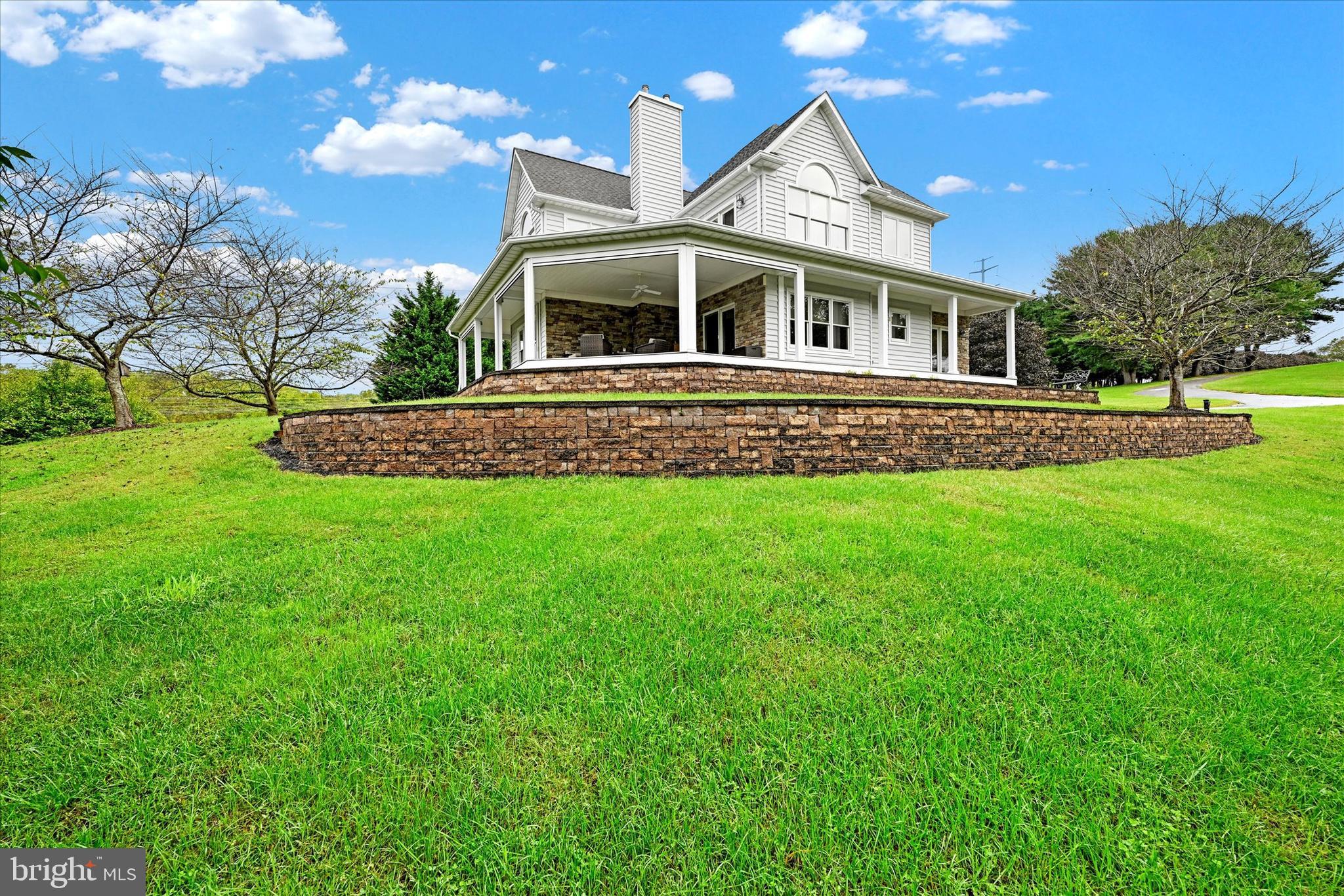 Imagine Owning this Beautiful Home with 15+ Acres and Gated Entry!  A Wonderful Opportunity to Move Your Existing Dream to this Ideal Location.  This Outstanding, Spacious Colonial with Partial Wrap Around, Covered Porch has a Main Level Primary Suite , Gourmet Kitchen, Living Room with Fireplace and Main Level Laundry.  The Upper Level Offers Three Additional Bedrooms, Each of Which Have Walk-in Closets and Two of Which are Ensuite and an Open Sitting Room with Gas Fireplace that Could Easily be Converted to an Office or Additional Bedroom.  The Lower Level is Unfinished with High Ceilings for Easy Finishing and Access to the Three-Car Garage.  Additionally, There is a Five Bay 
Garage and a Two-Story Pole Building.