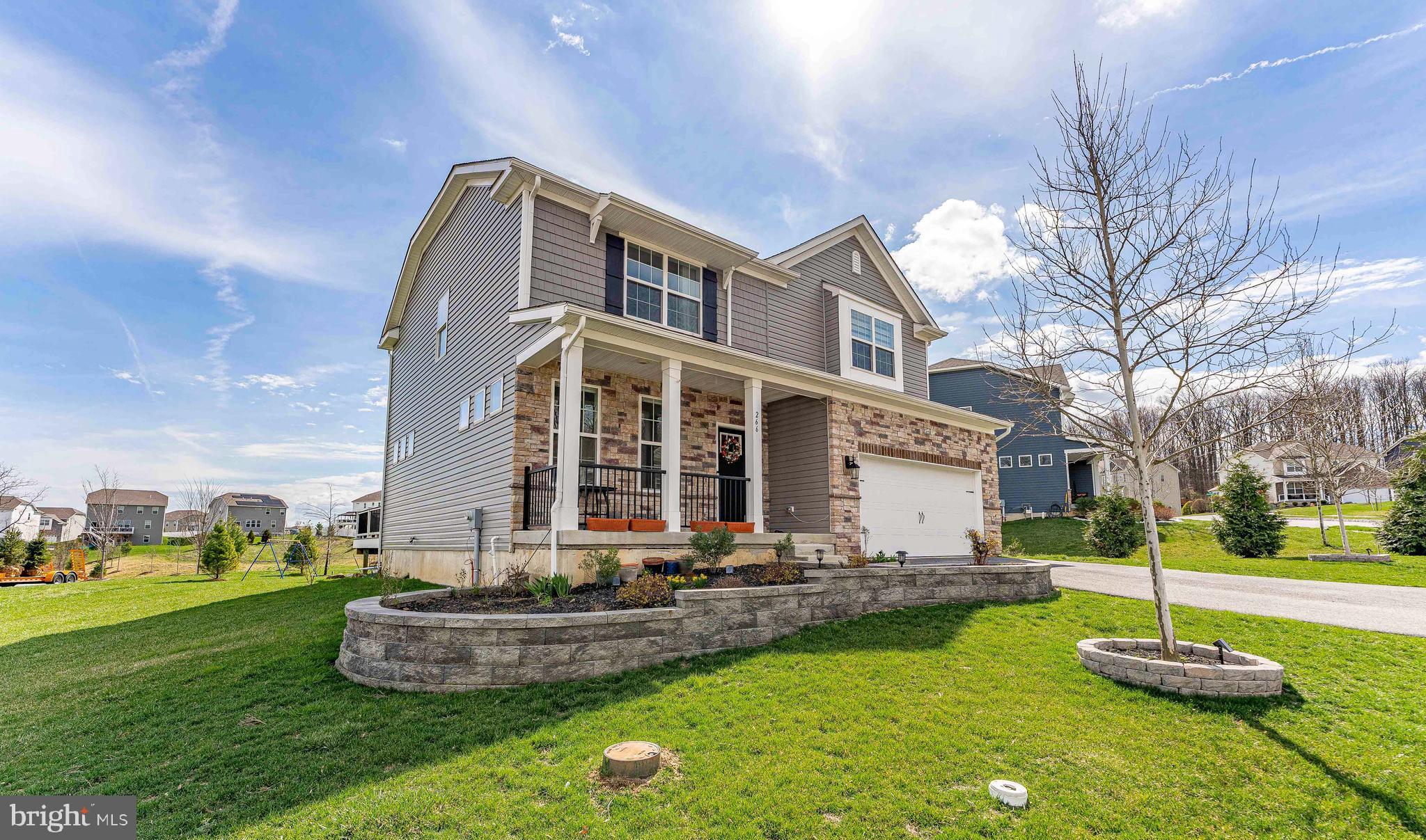 Welcome to 266 Arters Way, a 5-bedroom, 2.5-bath single-family home in Downingtown. As you approach, a charming front porch with stone accents sets the tone. Inside, the foyer features luxury vinyl plank flooring, which continues throughout much of the main level. The living room offers a bright and comfortable space with a ceiling light, flowing into the great room for additional living and entertaining space. The kitchen is well-appointed with quartz countertops, an island, stainless steel appliances, and luxury vinyl plank flooring. Just beyond, the breakfast room is filled with natural light from a triple window and includes a sliding door to the deck—perfect for indoor-outdoor living. A convenient powder room completes the main level. Upstairs, the primary bedroom features carpet flooring and a ceiling fan. The en-suite bathroom includes tile floors, a walk-in shower, a double-sink vanity, and a spacious walk-in closet. Three additional bedrooms, all with carpet flooring and ceiling lights—two with walk-in closets—offer flexible space for family, guests, or a home office. A full hall bathroom with tile flooring, a double-sink vanity, and a tub/shower combination serves this level, along with a conveniently located laundry room with attic access. The lower level expands the home’s functionality with a fifth bedroom featuring carpet flooring and an egress window, as well as a family room ideal for a media room, playroom, or additional living space. This level also includes the home’s utilities and rough plumbing for a future bathroom. Surrounded by mature trees and natural scenery, the home offers a private setting while still being just a short drive to local shopping, grocery stores, restaurants, and more. Don’t miss the opportunity to make 266 Arters Way your new home.