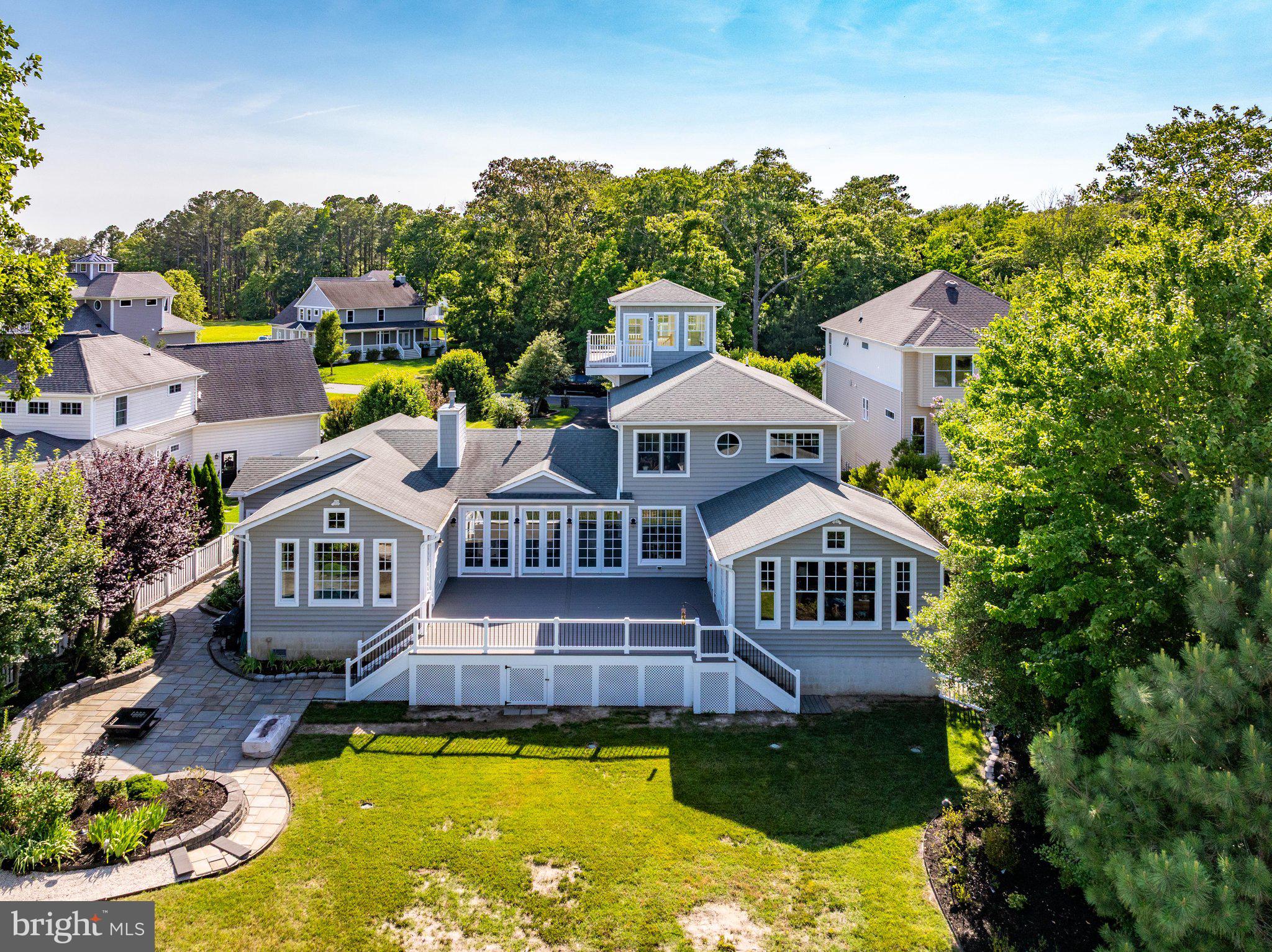 Professional Pictures are coming soon!  Nestled in the exclusive bayfront enclave of Bay Point Plantation, this beautiful coastal residence epitomizes luxury living, offering spectacular views of the Ocean City skyline. Built with intention for energy efficiency in 2011 featuring three separate Geothermal HVAC systems, this detached architectural masterpiece boasts over 4,500sqft with five spacious bedrooms and four full bathrooms with a 5th bathroom fully plumbed-in for future installation. Step inside to discover an expansive open floor plan that invites natural light to dance across the room from the floor-to-ceiling glass sliders that illuminate the natural beauty of Turville Creek with panoramic views of Ocean City's High Rise Row as its backdrop. The heart of the home is the gourmet kitchen, featuring an eat-in area perfect for casual dining, while the adjacent living spaces are enhanced by an elegant gas fireplace, creating a warm and inviting atmosphere for gatherings. Adjoining the primary living area is a 19'x19' sunroom with cathedral ceilings, built-in cabinets for entertaining, featuring its own geothermal HVAC system. The balloon framed sunroom, featuring magnificent views of Turville Creek and the OC skyline, was framed and designed ready to drop in an in-line Swim Spa with the concrete pad and electric in place. Just off the sunroom, a brand new, expansive TimberTech deck was just installed in 2026 featuring low-voltage landscape lighting which leads down to a huge flagstone patio area for additional outdoor living and entertainment space.  The Primary Suite, a true entry-level sanctuary, offers breathtaking bay views and is complemented by a Master Bathroom offering a Whirlpool Tub and ceramic tiled Rainforest ceiling shower, a spacious walk-in closet, plus an additional Half Bath with its own walk-in closet. A second entry-level bedroom with the plumbing for a future full bathroom is currently situated as an office. The stairway of the home leading to the second floor wraps around a space designed for a future elevator addition with a 6" concrete pad, electric and phone line already in place. The second floor offers an additional three bedrooms with two full baths and a large Bonus Room with its own fireplace, tv mount and surround sound speaker wiring. Traverse up to the cupola for a serene retreat setting, ideal for an intimate seating area to take in the spectacular, surrounding water views and the renown Golden Hour that illuminates Ocean City's skyline with rainbow hues each evening.  Every detail of this home has been meticulously designed, from the recessed lighting that highlights the home's architectural features to the exterior landscape lighting that creates ambiance for every occasion. The convenience of a main floor laundry room just off the four-car garage adds to the home's thoughtful design, while the Fire Department Knox Box provides peace of mind. Enjoy the tranquility of the tidal wetland surroundings, where nature's beauty is just outside your door here on Plantation Lane. As part of a prestigious gated community, residents enjoy exclusive access to a marina club, pier, and dock, perfect for boating enthusiasts or for crabbing, fishing and sightseeing. This luxurious residence is not just a home; it's a lifestyle choice that offers the perfect blend of comfort, elegance, and natural beauty. Experience the ultimate in coastal living, where every day feels like a vacation.
