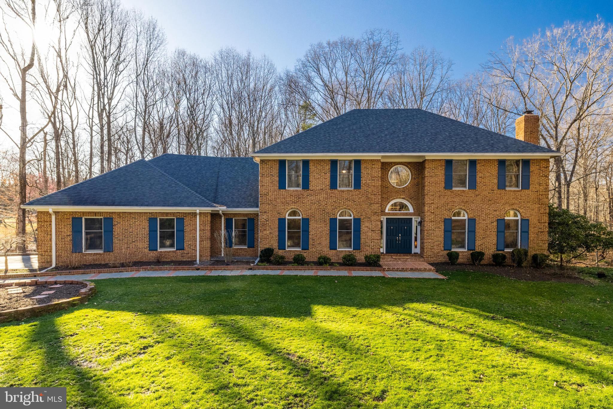 Introducing 400 Montpelier Road, an impressive brick colonial situated on 5 private wooded acres of land in the heart of Great Falls. This meticulously maintained home features many upgrades throughout including hardwood floors, crown molding and trim, custom windows, recessed lighting and more. You're going to fall in love with the spacious layout - perfect for family time and entertaining alike. A separate dining room and front sitting room cater to more formal gatherings while the eat-in kitchen is ideal for more casual family time. The gourmet kitchen is well lit with upper and under cabinet lighting and offers abundant countertop space. A sun room off the kitchen is filled with sunlight and includes skylights, casement windows, access onto the back deck and a charming brick wall. The family room features a cozy stone hearth and powered wood burning fireplace with access to the serene cedar screened porch. This three-season room with a vaulted ceiling and ceiling fan offers stunning wood features. Enjoy a cup of coffee with a book while overlooking the wooded landscape. The main level is rounded out with an office (with a closet, this could serve as a bedroom), two updated half baths, and a mud-room off the garage with laundry. 4 generous bedrooms upstairs include a primary suite with two walk-in closets, and a spa-like en-suite bath with heated floors, rain showerhead, towel warmer, and soaking tub. The finished walk-out lower level includes a kitchenette, spacious living area, full bedroom and full bath. Use this space as an in-law suite, to host family and friends, or use as a bonus rec-room for play time! Plenty of unfinished space for storage and easy access to all the homes systems including a newer HVAC. The three car garage includes an EV charging station! Revel in the private and tranquil outdoor space. Discover your green thumb with plenty of room for gardening, or adventure into the wooded landscape. A shed has space for your riding mower and other outdoor tools. Beautiful hardscape outlines the front of the home with a flat grassy space perfect for kids to play. Located in the desirable Langley High School pyramid and minutes to Tysons Corner, I-495 and the GW Parkway, this is true lifestyle property in the heart of Great Falls. Welcome home!