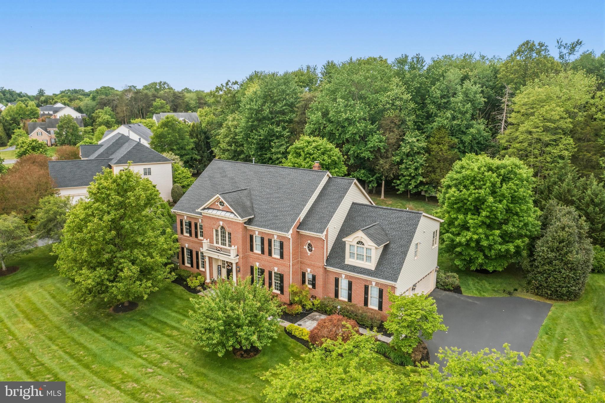 This amazing home is located in the highly sought-after Piedmont community and is situated on a .96 acre lot backing to woods. This beautiful home has 4 levels of finished living space, 6 bedrooms, 6.5 bathrooms, a 3-car side load garage, 5577 finished square feet on the main 3 levels and another 1235 finished square feet on the lower level.<br><br>The main level features a grand foyer with a set-back curved staircase that has wrought iron balusters. Walk through the grand foyer to your wonderful two-story great room featuring a floor-to-ceiling wood-burning fireplace. Off the great room is a private library with custom built-in bookshelves. The gourmet chef's kitchen features granite countertops, abundant cabinetry, a center island with a cooktop, stainless steel appliances, a breakfast bar and a sun-filled breakfast room overlooking the deck and wooded backyard. The spacious living room features stunning refinished hardwood floors and a double sided gas fireplace. Off the living room is a wonderful solarium with a double-sided gas fireplace. Completing the main level includes a laundry room and a half bathroom. <br><br>Upstairs you will find the luxurious primary suite, featuring vaulted ceiling, cozy sitting room and two walk-in closets, including one beautifully customized closet. The spa-inspired primary owner's bathroom features dual vanities, a frameless walk-in shower and a Jacuzzi tub. Completing the bedroom level are 2 additional large bedrooms with walk-in closets and 3 full bathrooms. Don't forget this home has a great 4th level with a loft, a 5th bedroom, and a full bathroom. <br><br>Continue entertaining in your spacious rec room featuring the 6th bedroom, a full bathroom and 2 large storage rooms. Recent updates and features since 2022 include 2 HVAC systems, an HVAC air scrubber system, a water heater, an electric panel breaker box, refinished kitchen cabinetry, refinished hardwood floors and staircase, wrought iron balusters  and owner's custom closet.  The roof was replaced in 2017!<br><br>Wonderful school zone with Battlefield High, Bull Run Middle & Mountain View Elementary. Piedmont is located near major transportation options and is one of Haymarket’s most desireable gated golf course resort communities. Amenities include 24/7 monitored gated security, an 18-hole championship golf course (social and full golf membership options available), a fitness center, indoor and outdoor pools, tennis and basketball courts, tot lots and walking paths. Don't miss the opportunity to make this amazing property your next home. Schedule a showing today!