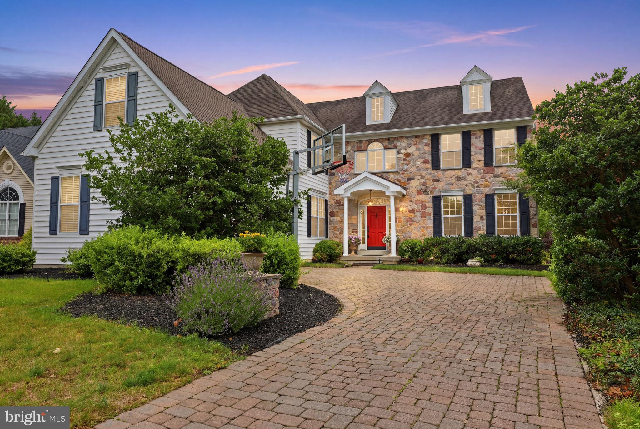 Nestled within the prestigious Orchards at Jericho, this distinguished brick-and-stone Colonial offers timeless architecture, refined interiors, and exceptional living in one of Bucks County’s most desirable communities.

A dramatic two-story foyer welcomes you into thoughtfully designed living spaces that blend elegance with everyday functionality. Just off the foyer, the private executive office provides an ideal work-from-home setting, while the expansive chef’s kitchen opens to generous gathering spaces designed for both entertaining and comfortable daily living. A convenient rear staircase leads directly to the family room, adding both character and practicality to the home's exceptional floor plan.

Adjacent to the oversized attached two-car garage, a well-appointed mudroom with washer and dryer enhances everyday convenience, offering direct interior access while the expansive driveway provides plenty of additional parking for guests.

Upstairs, the luxurious primary suite is a true retreat, featuring a sophisticated tray ceiling, a spacious en suite bath, and an oversized walk-in dressing room/closet. Every detail has been thoughtfully designed to create a space that is both elegant and inviting.

The finished lower level offers exceptional flexibility for recreation, fitness, hobbies, or additional entertaining, expanding the home's already generous living space.

Designed with comfort and peace of mind in mind, the home is equipped with a whole-house Generac generator, ensuring reliable backup power when needed.

Perfectly positioned for both relaxation and accessibility, the property is approximately 12 minutes from the vibrant shops, restaurants, galleries, and riverfront charm of historic New Hope Borough, while also being just minutes from Jericho National Golf Club, Peddler’s Village, Newtown, and Lambertville. Commuters will appreciate the easy access to major roadways and nearby rail service, providing convenient travel to both New York City and Washington, D.C.

Offering an exceptional combination of timeless design, thoughtful upgrades, an outstanding location, and a floor plan designed for today's lifestyle, this is a rare opportunity to own in one of Upper Makefield Township's premier neighborhoods.