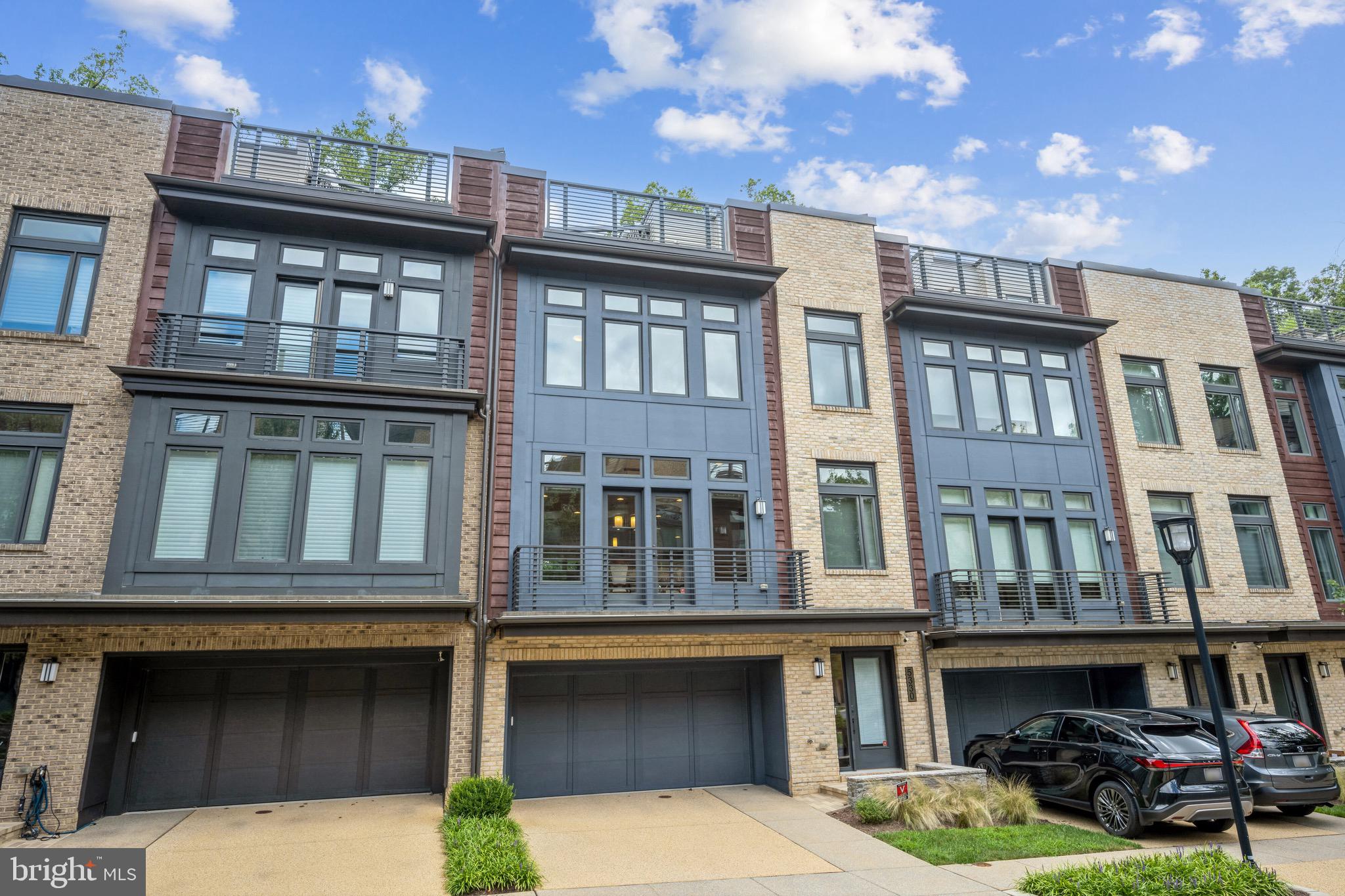 Contemporary EYA-built elevator townhome located in Bethesda's upscale Grosvenor Heights community near shopping, restaurants and Metro. This luxury residence offers expansive, sunlit living space on 4 levels ... and is the ultimate answer if you're looking to downsize, rightsize or just enjoy low-maintenance luxury living. Presented in pristine condition, this home provides more space than many single-family homes. Ten-foot ceilings, walls of large windows, balconies, a huge roof deck, a small yard, quartz countertops, Thermador appliances, open stairwells, upscale lighting and fixtures, and large walk-in closets - combine to make this is an outstanding residence. Enjoy a wonderful open floor plan; a gorgeous kitchen with expansive center isle and loaded with amenities; a large family room with fireplace and balcony, and a generous dining room. The luxurious primary bedroom suite offers a beautiful ensuite bath and walk-in closet. A separate laundry room is on the bedroom level, along with 2 additional bedrooms. The sensational roof deck offers a gas fireplace and sweeping views, for the best in entertaining under the sky! An entry level suite is currently set up as a home office but can be easily converted to a bedroom with en-suite bath and access to a grassy enclosed yard. Pull into the  oversized 2-car garage to access the house and use the elevator; your guests can park easily in the front. Given its amenities and ideal location near shops, Metro, restaurants, hiking trails and award-wining schools - this truly is your best choice in today's market. Come and see!