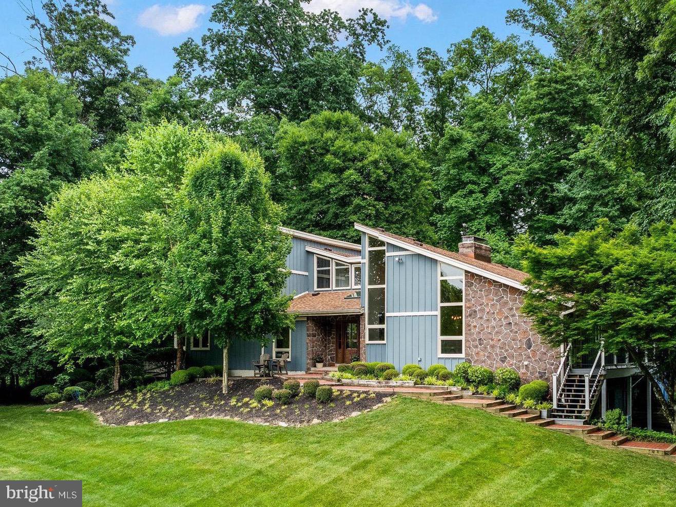 A rare opportunity awaits the lucky buyer to find this rare gem which boasts every amenity a discriminating homeowner is looking for.  Located at the end of private lane, the driveway leads to an impressive contemporary home, surrounded with attractive landscaping -demonstrating amazing curb appeal.   Enter the large foyer,  open to the formal living room, featuring a stone fireplace,  a wall of built-ins and sliding door open to the deck and patio.  The best of everything is found in the new gourmet kitchen featuring tons of cabinets, pot-filler at the high-end gas stove, farmhouse sink, island/peninsula, tile backsplash, stainless appliances, a breakfast space plus a wall of cabinets providing plenty of pantry space and storage.  Open to the kitchen  is the large family room,  with the stone fireplace as the focal point plus windows galore with views and access to the deck and patio entertaining space.   A nicely sized dining room with vaulted ceiling, and cool industrial style lighting add additional entertaining space.  The first floor primary bedroom suite is a wonderful retreat with new updated bathroom, featuring a huge shower, double vanities, and walk in closet.  An additional bonus is the adjacent screened porch providing space to enjoy morning coffee and the sounds of nature.  An additional bedroom and full bath with new tile flooring  complete the first floor.   The second floor is home to three additional bedrooms, each nicely sized, with new carpet and lovely views of the private lot, plus an  additional full bath and  loft/office area.  The lower level  features  a great room where watching movies, playing pool and working out in the exercise room and just hanging out with family and friends is a fun place.  An additional stone  fireplace, powder room, large  laundry room,  plus attractive engineered flooring add to the already fine features found in this amazing home.   If that weren't enough - the backyard oasis awaits--   the perfect setting - surrounded by plush greenery, specimen plantings is the newly renovated in- ground pool.    Sit around the pool or on the patio or in the hot tub  and enjoy the months of summer chillin' with family and friends.  The current owners have meticulously kept this amazing home with some major updates to include: heat pump, new windows (with exception of patio doors and hallway) , Master bath remodel, (2020), Guest bath, Pool renovation,(2023),  New carpet ( upstairs bedrooms2023) New roof and vents, Skylights,(2021),  New kitchen remodel with new appliances,(2022).  Replaced exterior deck w trex(2021). Septic inspection done and passed.  
You won't be disappointed - make this amazing house the place to call home!