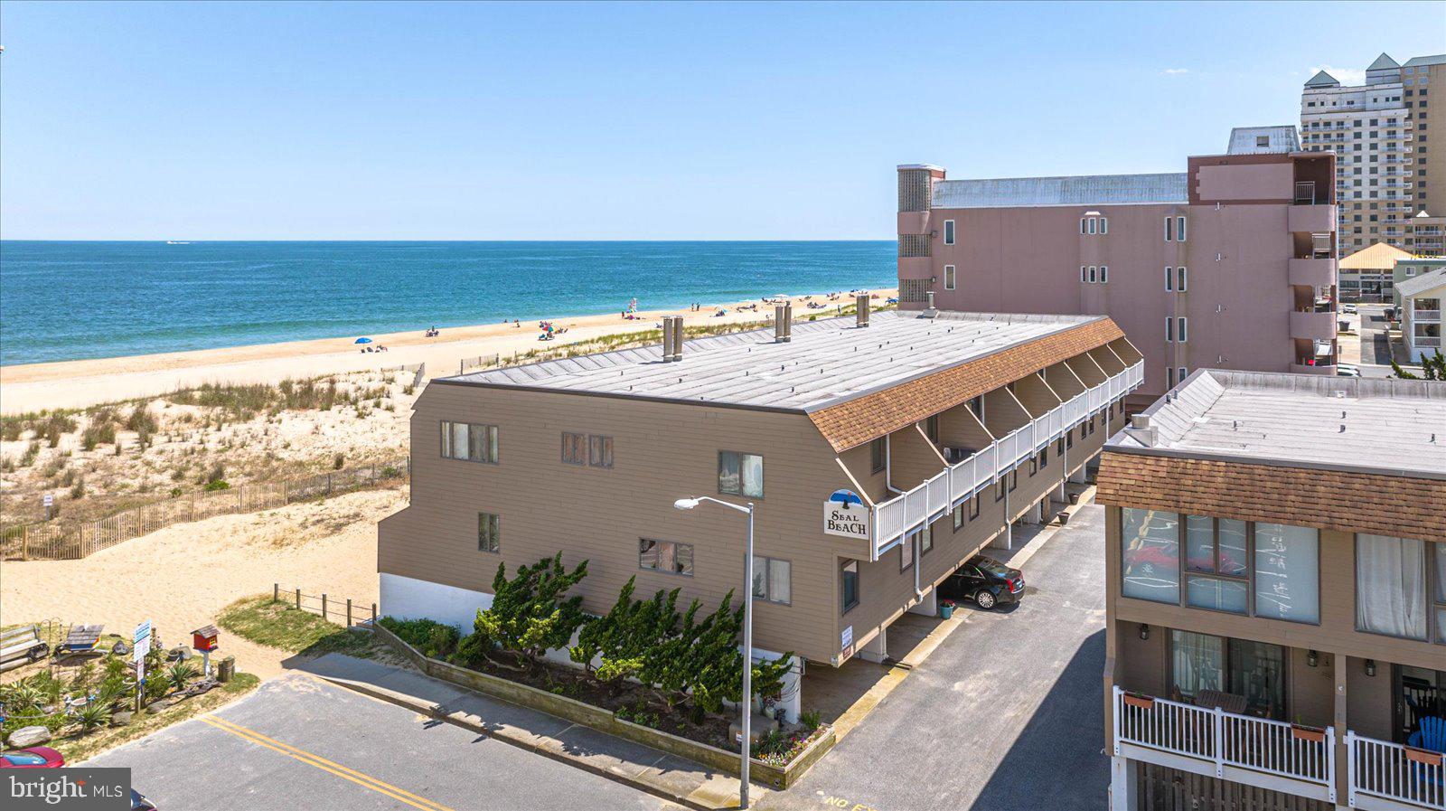 This is the quintessential beach house that you've been waiting for, located on the direct oceanfront with panoramic views of the waves and sand. Step inside to find a bright and open floor plan with a focus on the ocean and dune views. The kitchen boasts elevated cabinetry, Corian counter tops, stainless steel appliances, and a breakfast bar perfect for grabbing a bite to eat before hitting the beach. The dining area is ideal for sit-down meals and flows to the family room, making this a great space for friends and family to gather and entertain. Take the fun outside on the oversized sundeck with tranquil views of the ocean and beach. On the main level is a large bedroom with full bath access, and upstairs you'll find the oceanfront master suite with fantastic ocean views, a private oceanfront balcony to enjoy your morning coffee and evening wine, his-and-her closets, as well as an en-suite master bath. Also on this level is another large bedroom with its own private balcony and private full bath. With large bedrooms each having a full bath and an open living area, this home is perfect for entertaining and gathering at the beach. If you're looking for even more outdoor space, the ground level hosts a covered beachfront patio and a covered space to play in inclement weather days (or you can enclose it for even more indoor living space). The Seal Beach condominium is a well-run self-managed association that offers assigned parking with overflow spaces, as well as a private community beach area great for relaxing and soaking up some sun away from the crowds. Located in the prime mid-town location, not only are you just steps from the ocean, but you're within an easy walk to popular restaurants, bars, and entertainment. This property has been an exceptional rental property over the years, but is very clean and well-maintained, making it a great place to call your private beach retreat. Don't miss out on the opportunity to make a piece of classic Ocean City beach life your own with Seal Beach unit 5E.