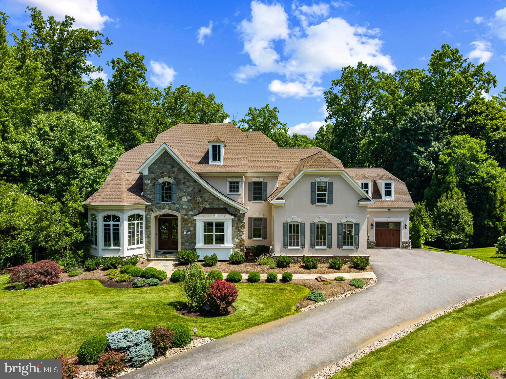 Welcome to this exceptional custom-built estate set on 3.1 acres in Wyatts Hill community. Offering three finished levels of thoughtfully designed living space, this five-bedroom, seven-bathroom home combines timeless architecture, modern updates, and resort-inspired outdoor living. A grand two-story foyer welcomes you with a sweeping curved staircase and soaring ceilings. The main level is designed for both everyday living and entertaining, featuring a formal dining room, private office, dramatic two-story family room with a fireplace, and a sunroom connected by French doors that fills the home with natural light. The gourmet kitchen serves as the heart of the home with an oversized center island, custom cabinetry, granite countertops, a spacious breakfast area, and a butler’s pantry, creating an ideal space for gatherings large and small. The main level also features a spacious primary suite with an en-suite bath, providing flexibility for a variety of living arrangements. An additional office, laundry room, and powder room complete the main level. Upstairs, a second primary suite offers a private retreat with a sitting area and en-suite bath. Three additional bedrooms each feature their own private en-suite bathrooms, providing comfort and privacy throughout the upper level. The walkout lower level expands the home’s living and entertaining space with a large recreation room, second kitchen, half bath, and abundant storage. Completed in 2023, the backyard was transformed into an exceptional outdoor living space featuring a heated saltwater pool, expansive patio, outdoor fireplace, and a fully equipped outdoor kitchen designed for entertaining and enjoying an outdoor lifestyle. Recent improvements include a new roof (2025), two new HVAC systems (2022), new wood front and garage doors, a Tesla EV charger, and a lawn irrigation system. Located in the desirable Wyatts Hill community with no HOA, this home offers convenient access to Historic Annapolis, BWI Airport, Fort Meade, Baltimore, Washington, D.C., and major commuter routes including I-97 and  Route 50.