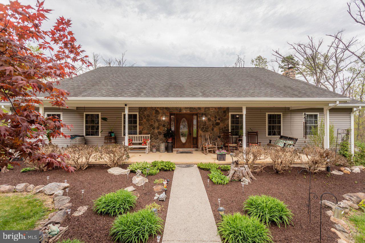 Welcome to 550 Mash Lane in Edinburg, VA—where space, functionality, and peaceful surroundings come together. This well-appointed 3-bedroom, 2-bath home offers a spacious open-concept layout upon entry featuring a large kitchen (new appliances in the last 3 years) that flows seamlessly into an oversized living area, perfect for everyday living and entertaining alike. Just off the main space, you’ll find a bright sunroom ideal for a home office, hobby room, or quiet retreat. This home is both spacious and easily accessible for those needing comfortable one level living without the compromise of space. 

This is the ultimate tranquil mountain retreat situated on a total of 10.242 acres of wooded privacy. This community also provides deeded National Forest access within walking distance from this home. Conveniently located near the Peters Mill Run/Taskers Gap OHV system, offering 36 miles of off-road trails for all skill levels.

The home offers generously sized bedrooms and bathrooms, along with a formal dining area for hosting gatherings and special occasions. Downstairs, a large unfinished walkout basement provides endless potential for future expansion, storage, or workshop space.

Step outside and take in the property’s standout features, including a 922 sq ft back deck (2 years old)—perfect for relaxing or entertaining—overlooking a scenic setting complete with a spring-fed pond. A detached 30x30 garage offers ample room for vehicles, equipment, or additional storage.

If you’re looking for space, versatility, and a serene setting just minutes from town, this property is a must-see.