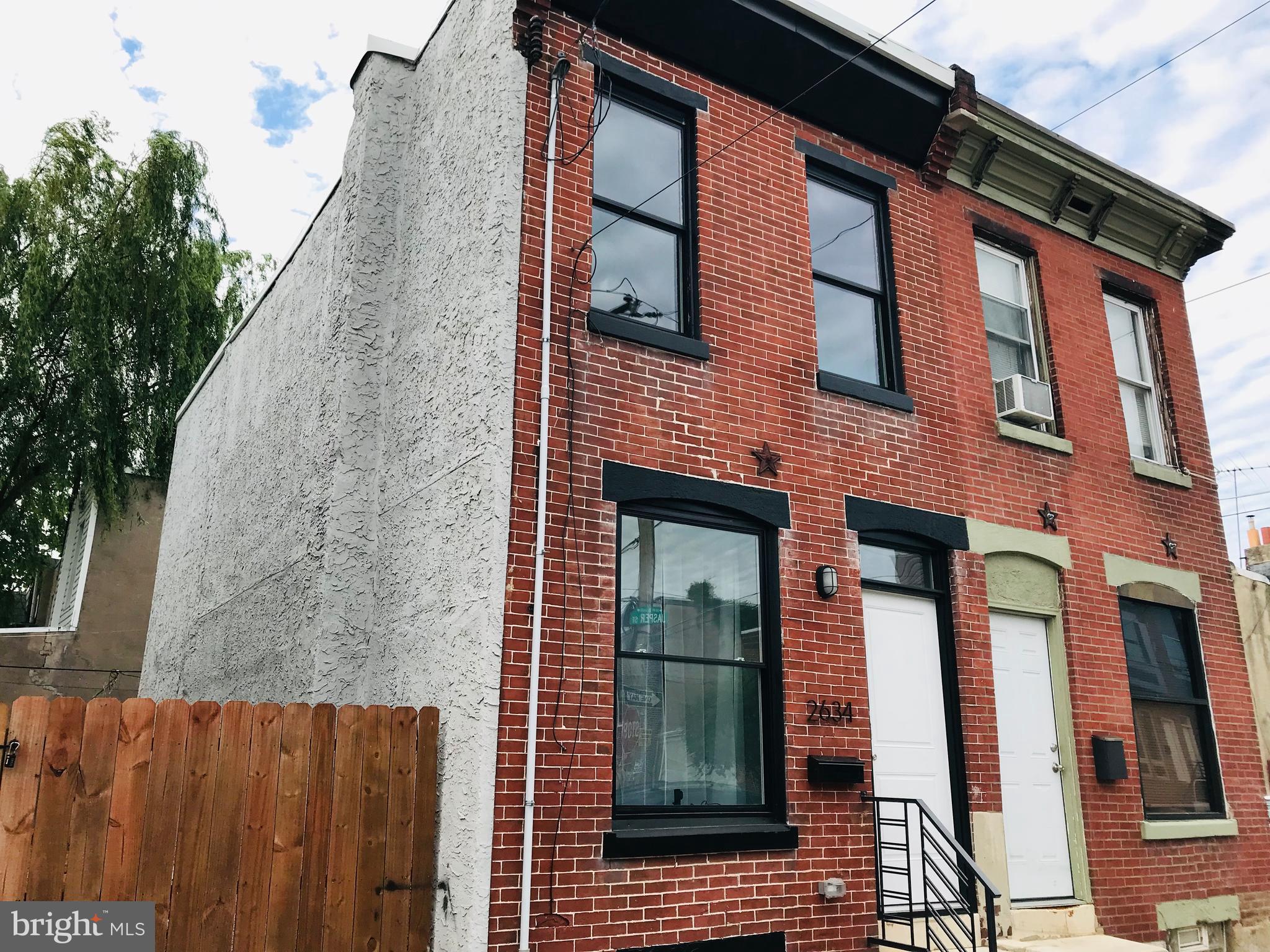 Whats affordable, has easy access to Center City, and is in one of Philadelphia's hottest neighborhoods? That's 2634 Jasper St!   Located in hot fishtown and only 2 blocks to the El Station, this outstanding Fully Rehabbed property should be on your must see list. You'll be wowed as soon as you walk in the front door by the beautiful hardwood floors. The first floor is an open concept layout with Living Room, Kitchen, coat closet and main level half bath. The all new kitchen boasts granite countertops, shaker style cabinets and all Stainless steel appliances including Refrigerator (with smart system), a 5-burner Samsung stove, dishwasher and disposal. Out the back you will find a large patio and a graded, seeded and fenced side lot for your enjoyment (Side Lot not included in sale).  Upstairs you will find hardwood floors throughout, two nice bedrooms with large closets and an all new main bath with walk-in all glass shower. It has great flow and great light.  Downstairs is a full clean basement.  Everything is new including Roof, Electrical, Plumbing, HVAC and Hot Water heater.