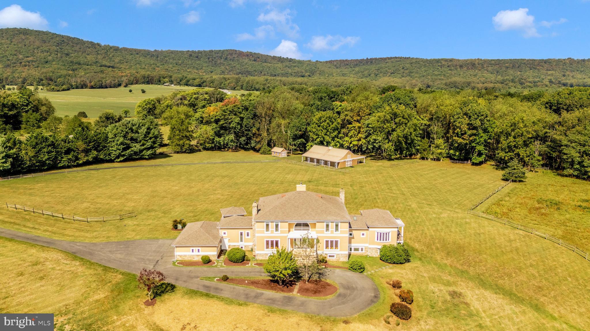 PRICE ADJUSTMENT on this unique Montgomery County property known as COMUS RUN.  Tucked away at the end of a cul de sac the estate home is ideally positioned on the private 45+ acres. The Thomas Manion designed custom built home with over  9,000 square feet of living space provides a comfortable layout designed for everyday living and entertaining.  Stunning views of the mountains, sunsets, sunrises, a private pond, pastures and woods.  6 bedroom, 6.5 bathrooms,  first floor owner’s suite.  The expansive finished lower level with separate entrance, private spaces, kitchen, 2 full bathrooms is ideal for multi generational living.  Upgraded systems include generator, geothermal HVAC plus many recent improvements.  An added attraction of a horse/livestock stable with 5 stalls, wash stall, tack room, 20 x 60 dressage ring and direct access to riding trails.    Excellent location within commuting distance of DC and Frederick and Sugarloaf Mountain, wineries, hiking and biking trails. Plus located in the sought after Poolesville School Cluster.