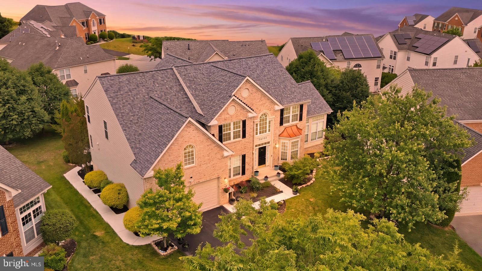 Welcome to 14107 Corunna Court, an exceptional brick-front Ryan Homes Avalon model ideally situated within the prestigious Villages of Wellington Estates, offering over 6,000 square feet of beautifully finished living space enhanced by a rare collection of structural extensions and luxury upgrades. From the moment you enter, rich red oak hardwood flooring flows through the elegant formal living and dining rooms, while a breathtaking conservatory showcases soaring cathedral ceilings and walls of windows that flood the home with natural light. The thoughtfully designed main level features a private study currently utilized as a first-floor bedroom adjacent to a full bath, creating the perfect guest or multigenerational suite. At the heart of the home, the gourmet kitchen impresses with granite countertops, a gas cooktop, double wall ovens, a walk-in pantry, abundant cabinetry, and seamless access to the spectacular morning room, sunroom, and solarium—each with basement space beneath—creating an unmatched footprint rarely found in today's market. The adjacent family room is a true showpiece featuring coffered ceilings, a gas fireplace, and a desirable four-foot rear extension that continues through the upper level. Upstairs, retreat to the expansive owner's suite complete with a massive sitting room, dual walk-in closets, and a spa-inspired bath featuring double vanities, ceramic tile, a soaking tub, and separate shower, while three generously sized secondary bedrooms, two additional full bathrooms, brand-new carpeting, and a neutral designer palette complete the upper level. The fully finished walkout lower level offers endless possibilities with six oversized windows and additional natural light, a sprawling recreation room, full wet bar, bonus room, loft area, full bathroom with Roman shower, and substantial storage and utility space. Outdoor living is equally impressive with a spacious deck, pergola, and concrete patio overlooking the private backyard setting. Perfectly positioned for commuters, residents enjoy convenient access to I-95, Route 29, Route 32, Route 200, Fort Meade, NSA, Johns Hopkins APL, BWI Airport, and Washington, D.C., while being moments from Maple Lawn, Towne Centre at Laurel, Columbia Town Center, premier shopping, dining, parks, and entertainment. Combining grand scale, sophisticated finishes, extraordinary living spaces, and an unbeatable location, this remarkable residence represents luxury living at its finest.
