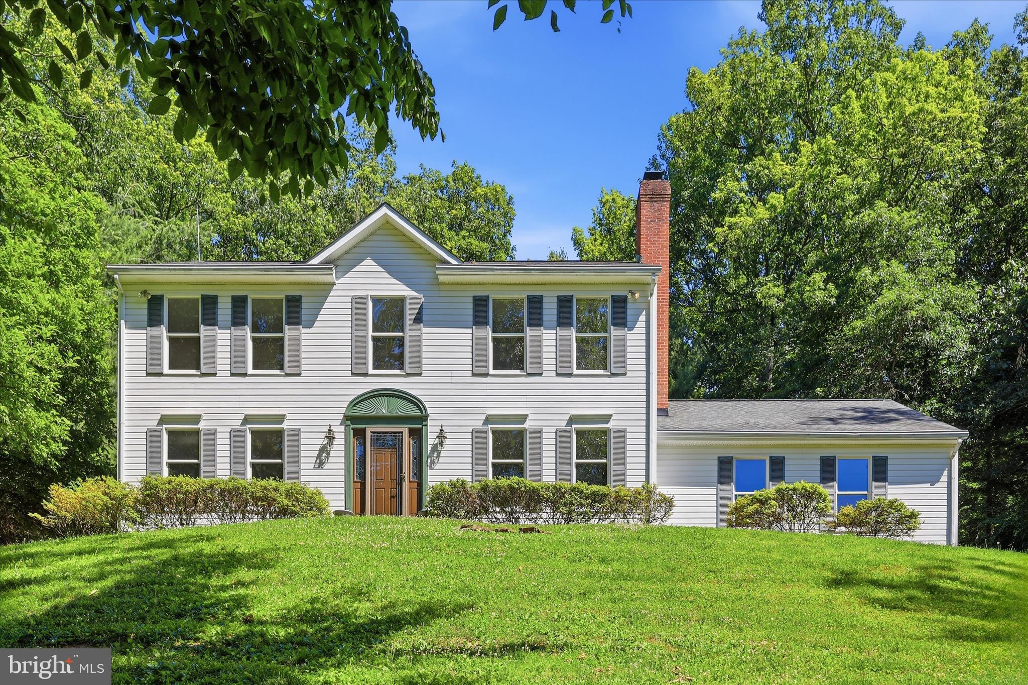 Welcome to 7219 Wilson Road, a beautifully updated Colonial nestled on a picturesque 1.08-acre lot in highly desirable Mount Airy. Offering 5 bedrooms, 2.5 baths, and 2,480 finished square feet, this exceptional home blends timeless charm with modern updates while providing the perfect balance of privacy and convenience.

Step inside the inviting foyer, where gleaming hardwood floors flow throughout the spacious living and dining rooms, creating an ideal setting for both everyday living and entertaining. New engineered wood flooring enhances the family room, breakfast area, and kitchen—the heart of the home—featuring stainless steel appliances, warm wood cabinetry, and abundant workspace. Just off the kitchen, the bright breakfast room opens through a sliding glass door to a screened porch and patio, seamlessly connecting indoor and outdoor living.

The cozy family room, anchored by a fireplace, offers a welcoming gathering space, while the formal living and dining rooms provide additional room for hosting family and friends. Upstairs, the expansive primary suite serves as a private retreat, complete with a walk-in closet and a spacious en-suite bath featuring a large vanity, jetted soaking tub, separate shower, and double window that fills the space with natural light. Four additional bedrooms, a convenient laundry chute, and a well-appointed hall bath complete the upper level.

The unfinished lower level offers tremendous potential, featuring a laundry area, rough-in plumbing for a future bathroom, and ample space to expand your living area to suit your needs.

Outside, you'll find plenty of room to relax, play, and entertain. Enjoy summer cookouts on the patio, dine al fresco, or unwind in the screened porch while taking in the peaceful surroundings. The expansive yard provides endless possibilities for recreation, gardening, pets, and outdoor enjoyment.

Recent updates include a new HVAC system (2025), fresh paint and new engineered wood flooring (2026), and a roof replacement (2019). Complete with a two-car garage and no HOA, this home is ideally located just minutes from downtown Mount Airy's shops, restaurants, and everyday conveniences, with easy access to I-70 for commuting to Frederick, Baltimore, and beyond. This is a rare opportunity to enjoy space, comfort, and convenience in one exceptional property.