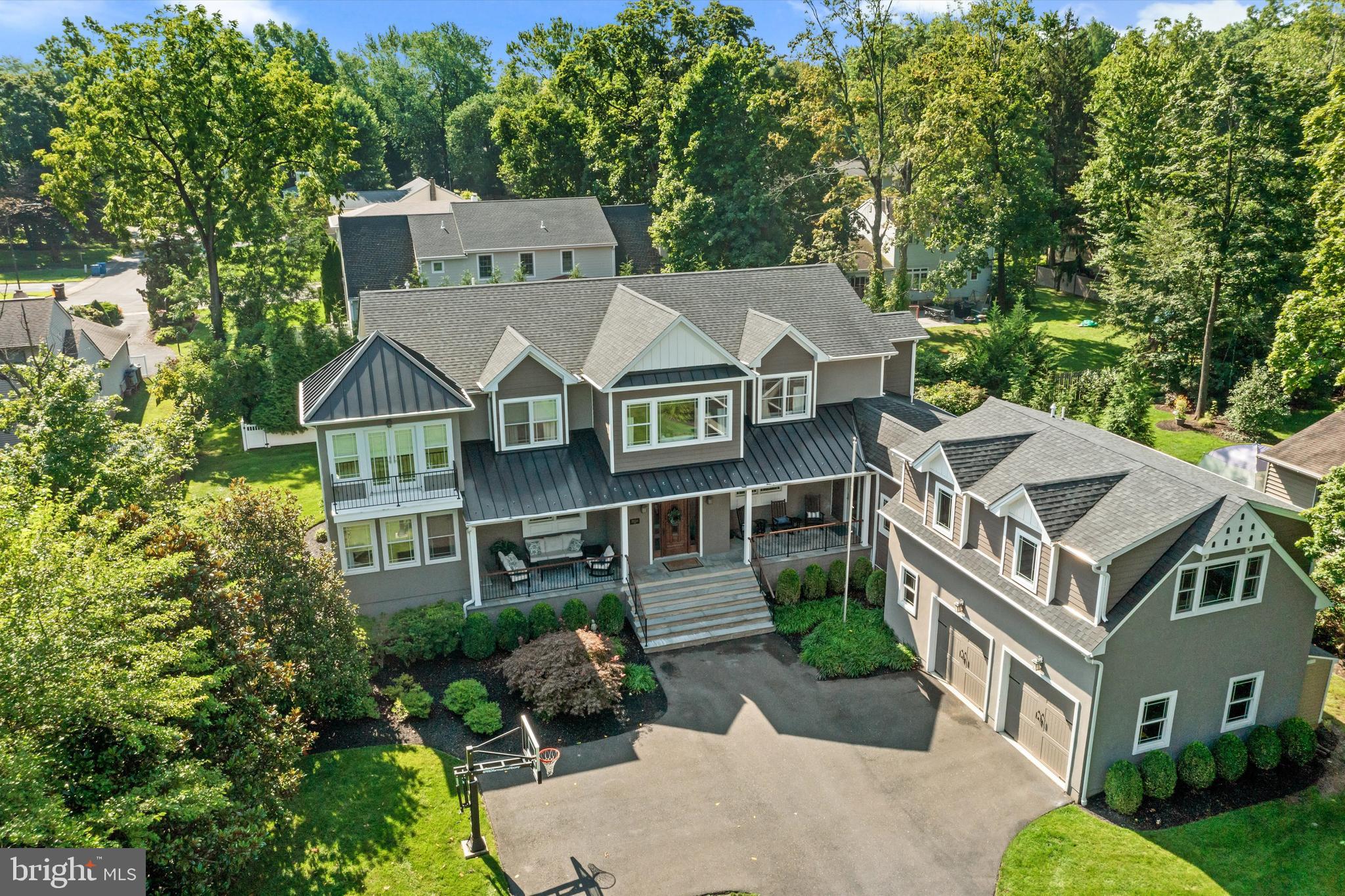 Welcome to 500 E Court Street! The original circa 1911 home was reimagined in 2013 with a complete renovation and expansion that resulted in this stunning and spacious, turnkey home that boasts approximately 5,000SF and modern-day amenities. 5 en suite bedrooms with walk-in closets, including a private guest suite over the 2-car garage.  Walking distance to the center of Doylestown and located across the street from the historic Fonthill Castle, nestled on 70 acres of lush grounds.  You cannot beat this location! Enter the driveway, adorned by columns, as you head into a spacious courtyard. The inviting covered porch with two sitting areas that flank the gorgeous 8 ft oak front door that welcomes you into the home.  Upon entering the home, you will immediately notice the light and airy feeling and the open floor plan with 9 ft ceilings, gorgeous smoked hickory wood flooring and oversized windows with deep sills. The foyer is flanked by a spacious dining room and living room with a two-way gas fireplace. Located just beyond the living room is a relaxing sunroom/family room with French doors that provide access to one of the covered porch areas. Tucked away beyond the living room and family room is a wonderful pub room/flex space, complete with a bar area with beer tap where you can enjoy the other side of the two-way fireplace that is shared with the living room. This room is also a great space for a home office/study.  The custom kitchen features rustic maple soft-close cabinets, new honed quartzite countertops, subway tile backsplash, under cabinet lighting, stainless steel appliances that include a six-burner gas range with a custom hood vent, dual ovens, custom pendant lighting above the island and recessed lighting. The kitchen also includes banquet seating for 8 and a built-in desk area. The kitchen provides access to the deck, which is the perfect area for grilling and dining al fresco. The spacious ½ acre lot provides an abundance of outdoor space that includes an expansive backyard. There is plenty of space for the next steward to customize the great outdoors to suit their needs.  There are endless possibilities to explore.  Back inside the house, just past the kitchen there is a butler pantry with a wine refrigerator, a huge walk-in pantry with secondary refrigerator-freezer, a large laundry/mud room with cubbies, access to an additional covered porch area. Continue down the hall to the 2-car garage with custom storage bin and rack system. Above the garage, a private staircase leads to a spacious 5th en suite bedroom with a living room. A perfect space for in-law, au pair or guest suite, that is separate from the main living quarters of the home. Head upstairs to the 2nd level of the main living quarters via either the main staircase or back staircase near the kitchen. There is a lovely sitting area at the top of the main staircase. The spacious primary bedroom suite with a double tray ceiling with lovely sitting room with French doors to a balcony that overlooks the front courtyard and greenery of the Fonthill estate. The primary suite bathroom includes radiant heated floors, a dual vanity, an oversized tiled shower with glass enclosure, a soaking tub, private water closet, linen closet and access to the spacious walk-in closet with custom built-ins. Just down the hall there are 3 additional large en suite bedrooms each with combination tub-showers and custom walk-in closets. The lower level provides a large finished area that is the perfect space for a game room, craft room, gym and more. There is also a large unfinished area that is great for storage. 3-Zone HVAC, 6-Zone Irrigation System and Central Vac. Enjoy all that Doylestown Borough offers – wonderful restaurants, shops, museums, county theater, parks and various festivals. Doylestown is rich in history and the arts.  Close in proximity to major routes and walking distance to everything, including mass transit.