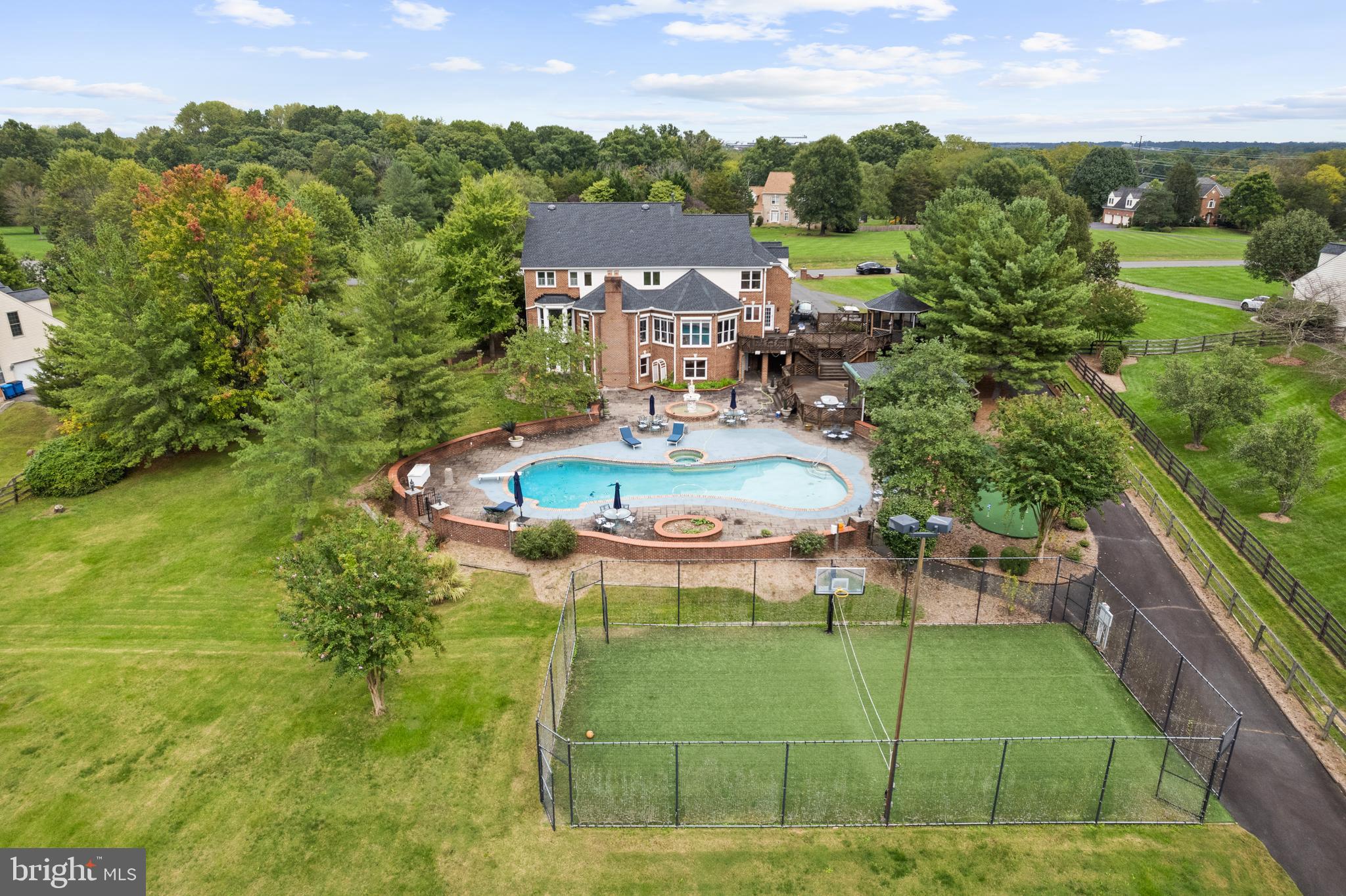 OPEN SATURDAY 12-2 AND SUNDAY 1-3!

VACATION AT HOME — Luxury Estate on 10 Acres with Fairfax County Water & Sewage!
Welcome to this all-brick estate features over $1.2M+ in upgrades and renovations, blending luxury, privacy, comfort, and endless entertainment. Outdoor features include 60’ heated swimming pool with new pump, skimmers & lines; 66’ x 34’ multi-sport court ; Athletic field (65 yds x 55 yds) + Putting green; Large Multi-level deck built with Brazilian paloupe wood., covered pavilion with built in benches on lower level, and screened gazebo on the upper level, both equipped with ceiling fans and outlets; Elegant multi-tiered water fountain on the swimming pool level. The interior is home to a gourmet kitchen with custom cherry cabinets, heated floors, 2 NEW Bosch 800 series convection ovens, new Dacor cooktop, Ferguson faucet set, Bosch dishwasher and refrigerator; hardwood floors throughout, oversized laundry & mudroom with storage; octagon conservatory, private office, formal dining, dual staircases. Find a large bedroom with full bath, bright and open with French doors & windows, and high ceilings, wet bar, recreation room, exercise room all in the lower level. Upper Level features include 5 large bedrooms, 3 full baths, and new roof with 30-year architectural shingles. Additional highlights and updates include: 6 NEW Andersen 400 series double-hung windows in primary bath and dressing area, powered shutters on rear levels, detached shed with full electricity, original garage converted to oversized laundry suite with cabinets, closet & separate storage.  It can be converted back and or plenty of space to build new, wide circular driveway + side driveways will accommodates 10+ cars comfortably, rare 1,800’ deep lot (six football fields long). Enjoy privacy, luxury, and resort-style living — all just steps from home.