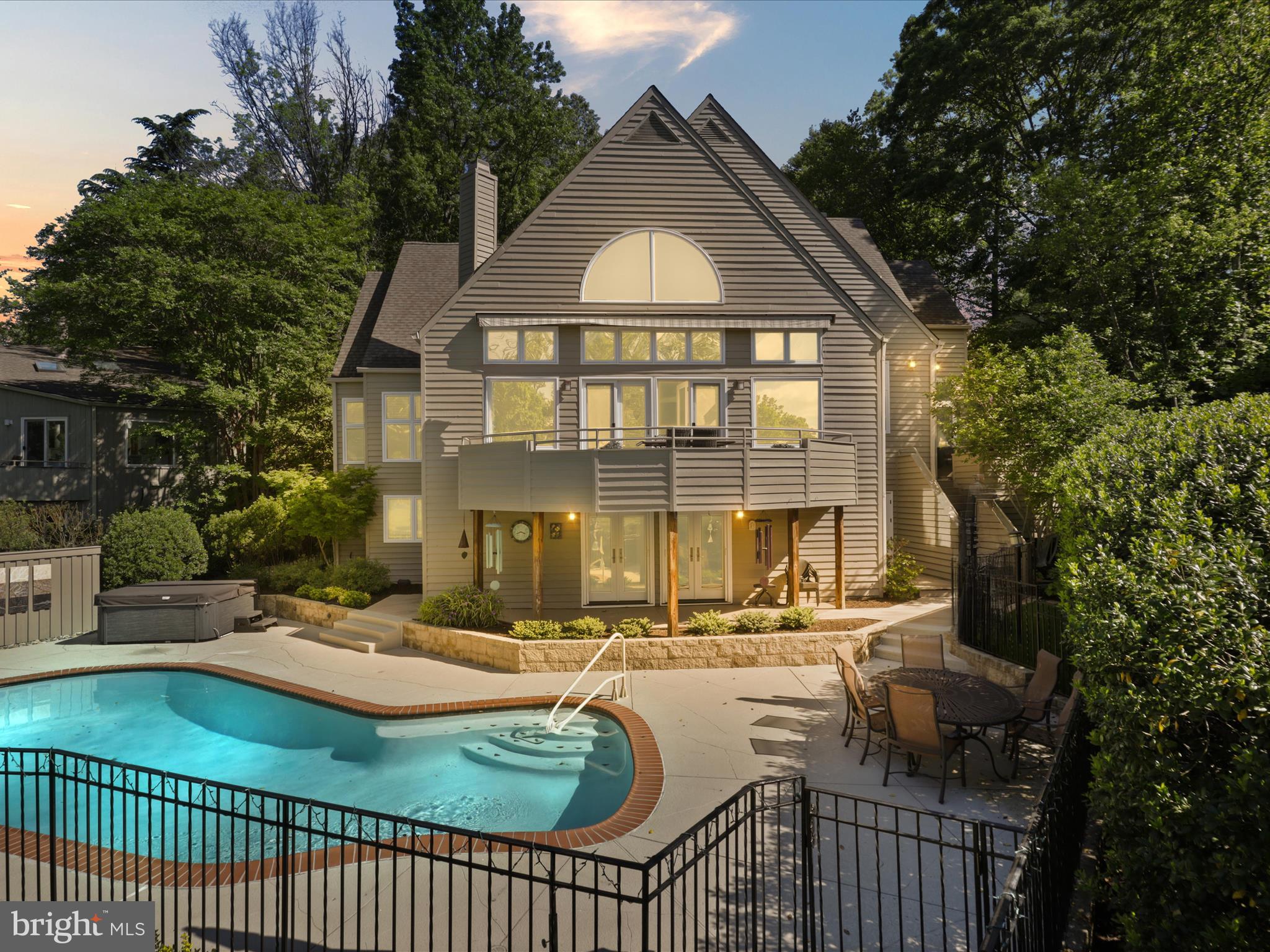 Contemporary Lakefront Gem on Reston’s Prestigious Lake Newport.  Nestled in a serene & picturesque setting along the shoreline of Lake Newport, this unique & unparalleled home is located in the lakeside community of Greenwich Point.  Built by CP1 & situated on a .43 acre, professionally landscaped, wooded waterfront lot, this expansive 5,100+ square foot home boasts a private drive, brick entryway, & rich wood cedar siding that blends seamlessly with the natural beauty of the outdoor environment. From your private dock, immerse yourself in wildlife watching, fishing, canoeing, kayaking, & paddle boarding for waterside living at its finest. As you step into the main level, soaring vaulted ceilings & imaginative windows create unique & spacious interiors basked in light. A sunken living & dining room, including gleaming hardwood floors, skylights, marble surround gas fireplace, & a relaxing window seat, sets the stage for the perfect spot to enjoy sunsets across the lake. French doors lead from the main level to a beautifully curved backyard balcony, offering stunning views of the lake, heated in-ground pool, hot tub, & terrace below. The spacious kitchen, thoughtfully renovated in 2011, features top-tier appliances, including a double oven & gas cooktop, a center island with built-in storage,  & double pantries. Directly off the kitchen, the family room invites comfort with a gas fireplace & built-in entertainment center, perfect for social gatherings or simply relaxing by the fire. Sliding glass doors open to a deck equipped with a new gas grill. The deck’s steps provide direct access to the pool & terrace, creating a seamless indoor-outdoor flow for effortless grilling & poolside enjoyment. A first-floor laundry room, off the family room, provides access to the attached two-car garage. The expansive main floor primary suite offers a serene retreat, bathed in natural light with breathtaking lake views. Vaulted ceilings, a generous dressing area, oversized walk-in closet, & bathroom area with a sunken roman-style soaking bathtub & separate shower create a perfect sanctuary to relax & unwind.  A fully finished sprawling lower level is creatively designed to accommodate multiple zones for relaxation, recreation, & entertainment. The kitchenette area features tons of cabinets, a sink, mini refrigerator, dishwasher,  microwave, & center island with seating. Wine connoisseurs will love the wet bar with a full-size wine refrigerator, wine cabinet, & dual storage racks. The recreation area includes a pool table along with ample room for a media lounge, game space, or crafting. The open cubbies provide the perfect solution for organizing books, games, or craft supplies. In addition, multiple storage areas & a large utility room can fulfill all your indoor & outdoor storage needs. The family room offers walk-out access to the pool deck & terrace for easy entertaining indoors & out. A private guest bedroom suite with full bath is an added plus & offers an ideal space for guests, extended family, or an au pair. The upper level features an inviting loft that overlooks the grand living area, plus 3 additional bedrooms & 2 full baths, completing the impressive 5-bedroom, 5.5-bath layout. A one-of-a-kind bedroom showcases a spiral staircase leading to a private loft - an imaginative space enhanced by built-in bookcases & full of potential for work, play, or quiet retreat. Enjoy all the Reston Association amenities, including 1,350 acres of open space, 4 lakes, 15 pools, tennis & multipurpose courts, ball fields, tot lots, picnic areas, event spaces,  & 55 miles of trails. Ideally located near North Point Village Center, minutes from Reston Town Center & easy Metro & airport access, this home offers tranquility, luxury, & convenience.  Inside & out, the unique layout ​& surrounding features of this home distinguish it from other properties on the market, making it a remarkable residence that should not be missed.  Click on the videos!