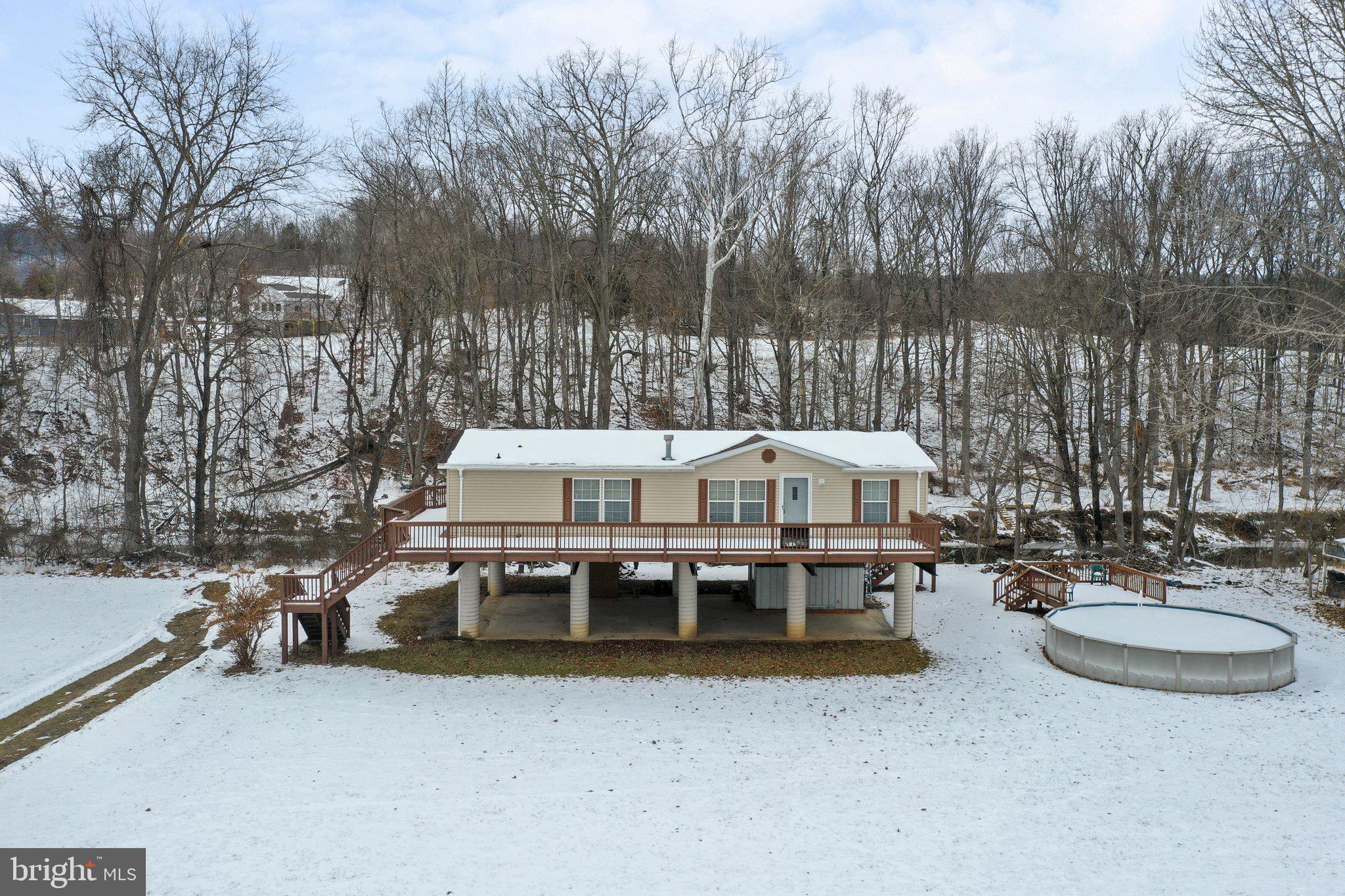 Nestled along the picturesque 1057 Hummingbird Ln in Capon Bridge West Virginia, this riverfront property epitomizes the essence of tranquil living. Step inside, and you'll be greeted by the allure of newly installed luxury vinyl plank flooring, seamlessly complementing the open concept design of the home. The three spacious bedrooms and two full bathrooms provide a comfortable retreat, with the primary bedroom standing out for its generous space, private sitting room, and  luxurious en-suite bath featuring a large soaking tub and tasteful tile flooring—a sanctuary for relaxation. Beyond the interior, the property unfolds its charm with two expansive decks that offer sweeping views of the Cacapon River and the surrounding mountains. Head down the stairs to the water's edge, and you'll find yourself immersed in the serenity of riverside living. This gorgeous riverfront oasis presents an opportunity to escape into nature's beauty—don't miss the chance to make it your own and embrace the tranquility of this stunning retreat.
This fully furnished home could be a full time, part time or short term rental.
