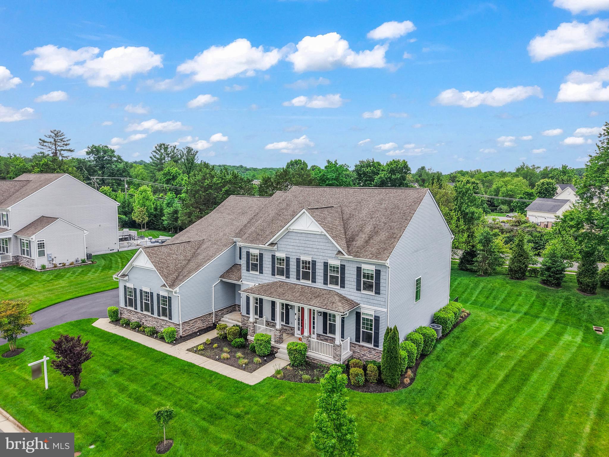 Situated on a premier 0.57-acre cul-de-sac lot, this 2019-built estate offers an unparalleled living experience spanning over 8,100 square feet of meticulously designed space. The residence makes an immediate impression with its commanding Colonial silhouette and side-load three-car garage, opening into a gallery-inspired interior defined by light oak wide-plank flooring, matte black accents, and soaring ceilings. The heart of the home is the great room, where a floor-to-ceiling black marble fireplace serves as a stunning focal point, framed by a wall of windows that flood the home with natural light and invite the outdoors in. The kitchen is a masterclass in contemporary design, equipped with sleek cabinetry, premium quartz countertops, and a massive waterfall island that transitions seamlessly into the open-concept living areas. Designed for the modern lifestyle, the main level includes a versatile guest suite with a full ensuite bath, ideal for visitors. Upstairs, the primary sanctuary serves as a true retreat, boasting a spa-inspired bath with a freestanding soaking tub, a seamless glass shower, and dual designer vanities. Every secondary bedroom is a private oasis, each thoughtfully paired with its own beautifully appointed ensuite bathroom to ensure comfort for family and guests alike. The home’s lifestyle potential extends to the expansive walk-up lower level, a versatile space perfectly suited for a state-of-the-art home theater, private gym, or recreation space and ability to finish space for an additional 6th legal bedroom.  The double-wide doors invite an abundance of natural light into the space. Outside, the flat backyard opens to a deck with custom lighting and offers a rare level of privacy and a blank canvas for a custom pool, pavilion, or outdoor kitchen. Meticulously maintained and featuring high-end upgrades such as a comprehensive water treatment system and sprinkler system, this property offers the peace of mind of recent construction. Located just minutes from the Silver Line Metro, Reston Town Center, and the Dulles tech corridor, this is a rare opportunity to own a modern masterpiece in the heart of Herndon’s most sought-after landscape.