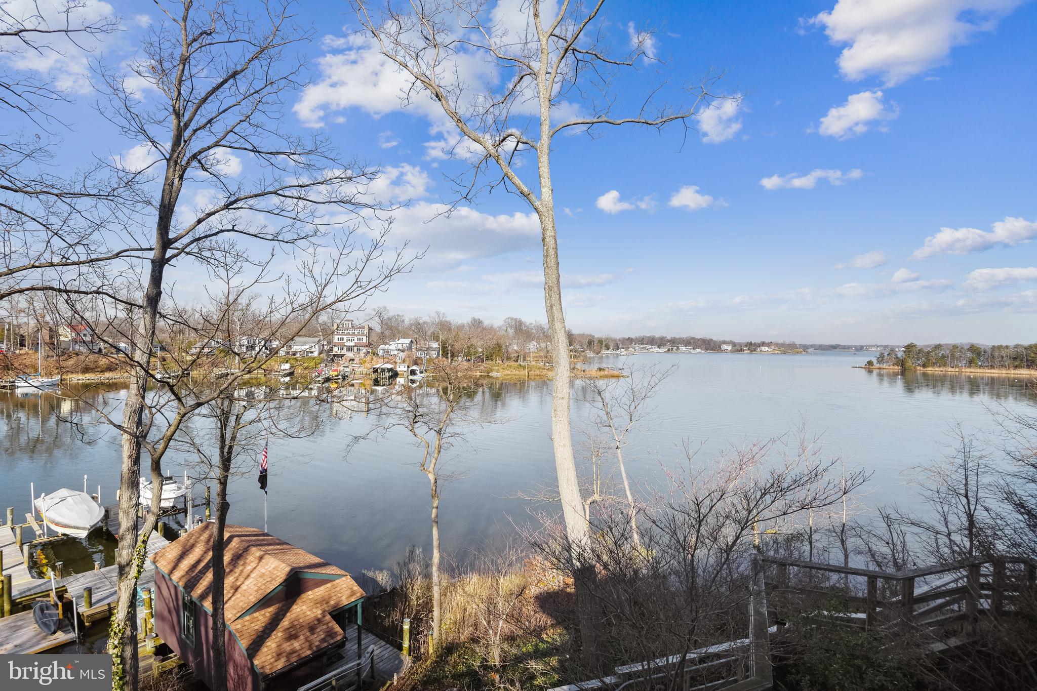 Sellers have adjusted price to $1,395,000!   Your new waterfront home with panoramic deep water views, 339' of water frontage on .59 acre private lot, private dock with multiple deepwater protected slips and a boat house too with and a gorgeous  3 or 4 bedroom 3631 square foot is ready and waiting for you! Love your vaulted ceilings, walls of windows,  hardwood flooring and spacious decks with beautiful water views.  Relax the minute you step into 310 Arbutus Drive.  The kitchen with center island is open to family and rec rooms with vaulted wood ceilings and walls of windows overlooking Glebe Creek.    Dining room is open to rec and family rooms which allows for open everyday living  with plenty of space for everyone.  Main level den with powder room could easily be used as an office or a 4th bedroom on the main level.  Relax in your owners suite with lavish bath and large walk in closet .  Two additional bedrooms , full bathroom and laundry room are upstairs as well.  The lower level workshop  could also be used as a craft studio, office,  exercise room or teenage hangout .     The separate shed used as a studio has electric, heat/ac and a window with a water view too! Your private dock has multiple slips two with Hi N Dry Boat Lifts, elevated bunks include carpet and elevated cat walk rated for 10,000 pounds.  The third lift is a Tide Tamer Industries inc Aluminum Swinger Boat Lift rated at 1500 pounds which can be used for small boat or jet skis.   Boathouse is complete with bar, refrigerator and plenty of space  to host your crab feast.  Community of Glebe Heights is voluntary and offers a beach, boat ramp, boat slips and kayack racks for a nominal fee.  Home is minutes from Annapolis and a very easy commute to DC.
