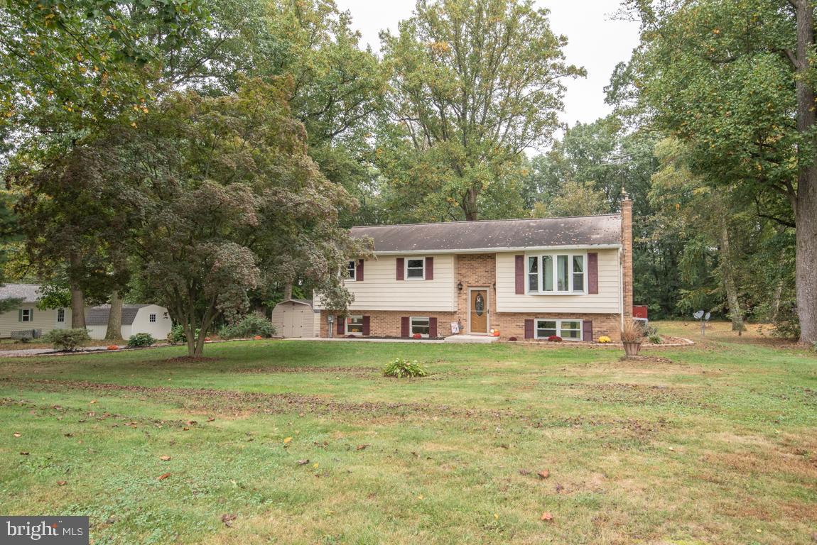 This spacious 3 bedroom 2 bath Bi-level located on a 1.06-acre wooded lot is looking for new owners.  The foyer is welcoming and the accent wall really ties the room together with the large bay window in the living room.  The kitchen with updated appliances and island is a great space that opens into the dining room.  The finished lower level with a pellet stove insert will keep you warm on chilly winter nights.  Walkout on the newly installed patio and retaining wall to enjoy family gatherings. Let’s talk about the “She Shed or Man Cave” that had an inviting porch and electricity.  Such a fun space to make your own.