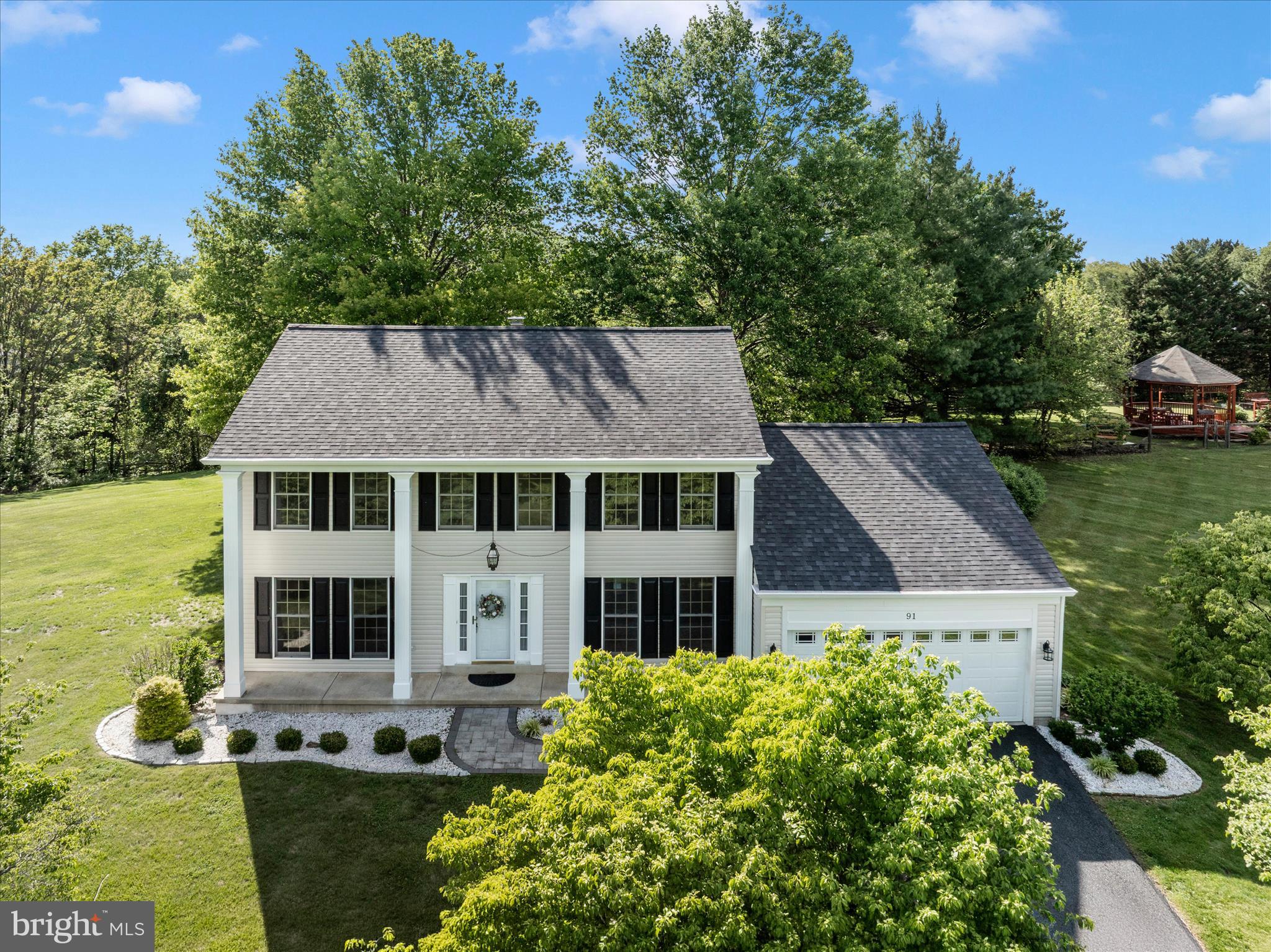 Stately 4-bedroom, 2.5-bath Colonial set on a picturesque 1.52-acre lot, offering a private and impressive approach with a long, tree-lined driveway leading to the home’s welcoming front porch with elegant pillars. This beautifully maintained property combines timeless charm with a spacious, functional layout ideal for both everyday living and entertaining.

The main level features a formal living room with wood flooring, crown molding, and abundant natural light. A private library or home office with French doors and floor to ceiling windows provides the perfect work from home retreat. The formal dining room is enhanced with crown molding, chair rail, and classic panel detailing.

The spacious family room offers a cozy setting with plush carpeting, a wood burning fireplace, and detailed trim work, with French doors leading to the deck for seamless indoor outdoor living. The kitchen features all appliances conveying, along with a bright breakfast area and additional access to the deck,  ideal for morning coffee or entertaining.

Upstairs, you’ll find four generously sized bedrooms, including an inviting owner’s suite with a walk in closet and a well appointed en suite bath featuring a soaking tub, separate shower, and double vanity. The hall bath also includes a double vanity for added convenience.

Additional highlights include a full unfinished basement with rough in for a future bathroom, offering endless possibilities for expansion, and a two car garage. Recent updates include a new roof and siding (2025), along with gutter guards for low maintenance living.

This property offers the perfect blend of space, privacy, and classic elegance, ready to welcome you home.