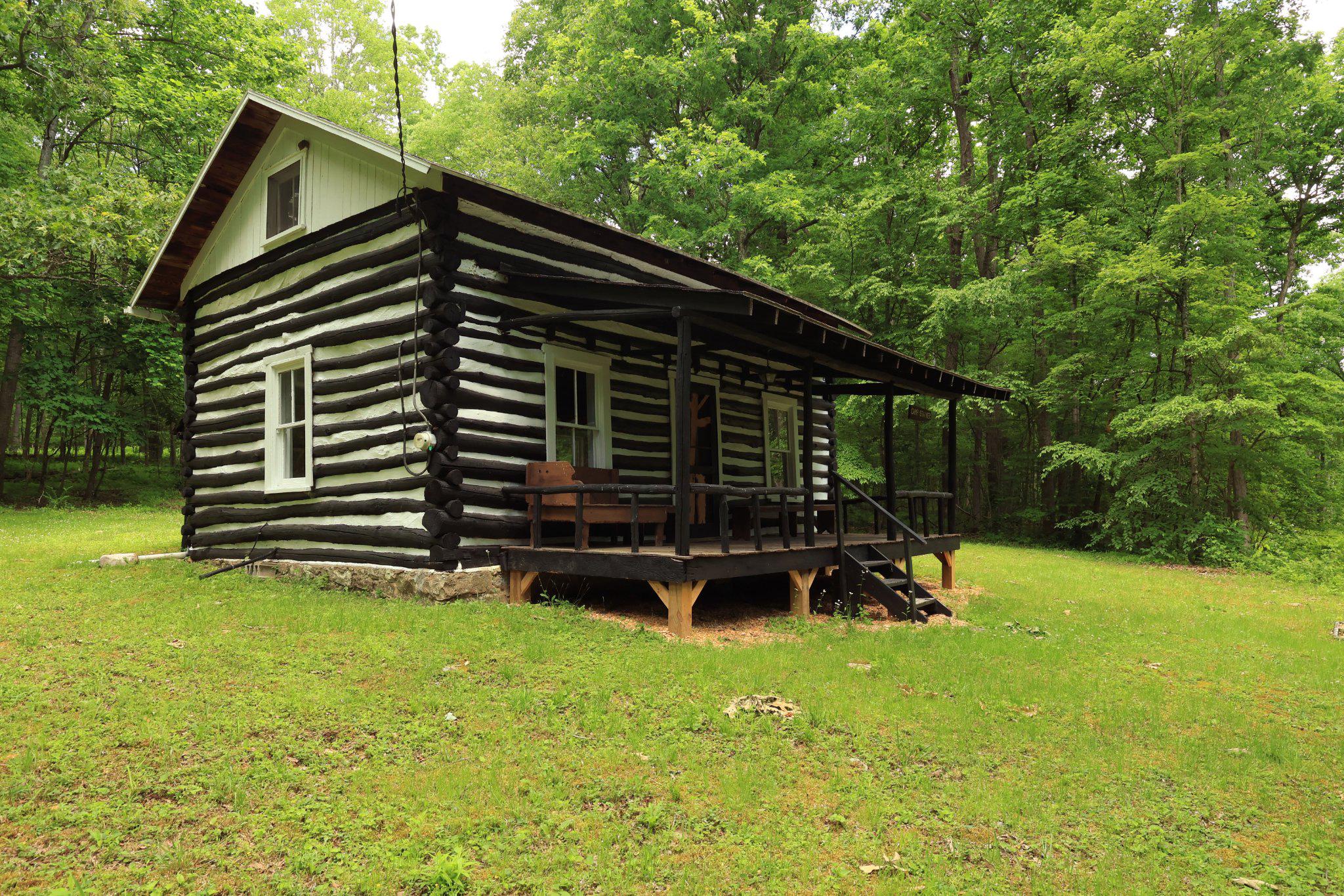 Discover a peaceful escape at 4464 Tram Rd, a secluded log cabin found miles within the Rothrock State Forest in Petersburg, Pennsylvania. This 800 sq ft meticulously restored rustic cabin on leased land is surrounded by thousands of acres of protected land, and is the perfect spot for hunting, hiking, fishing, and many other recreational activities. Inside you can find a newly redone cozy living space with a brand new wood-burning stove with newly put in windows that provide great natural light . The layout also includes a kitchen area, bathroom area, and a great loft area perfect for rest after a long day. Other amenities include electricity and hot water. Outside features a covered porch perfect for relaxation, and a scenery of natural beauty. About 2 miles from the cabin you can find Globe Run Creek, the perfect spot for trout fishing, as well as Blue Diamond Camp and Lake less than 3 miles away. This cabin is also close-by to places like Penn State University, Shaver’s Creek Environmental Center, Whipple Dam State Park, Lake Perez, and Raystown Lake.