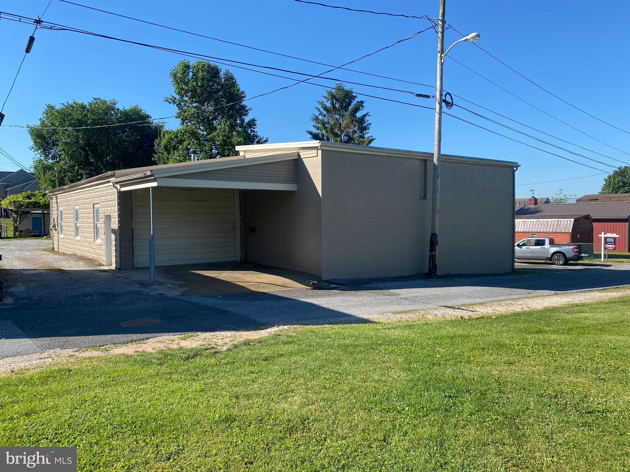 Multiple use Building / Warehouse Facility in Good Repair located near center of Taneytown. One Level entry that could be used for many types of business opportunities including automotive, warehousing,  painting shop, storage, carpet business, retail outlet, truck shop, etc. or many , many different businesses. Has been used in the past for Trucking Business shop and truck parking,  and for last 25 years by local painting contractor. Building is heated by waste oil furance that can be converted to regular oil.Has bathroom  and building has been insulated on side walls and overhead, electric has been ungraded and replacement windows have been installed. Large 14 ft by 14 ft. overhead door and high ceilings are in one section of building with 10 ft high and 14 ft. wide door located on another section of the  " L " SHAPED  building. Interior walls have been recently painted on both sides of building, along with the exterior walls of the building. Ample parking for several larger trucks and or cars are at the site. Location is only approx. 100 feet from Route #140 west or West Baltimore Street in Taneytown with Church Rd. running right beside building and Memorial Drive within 50 feet,  for easy access to location and parking. The cost to purchase the .15 acre parcel and to build a building of this size in today's market makes this an investment that may need to be considered if you are looking to open or relocate your present or future business.