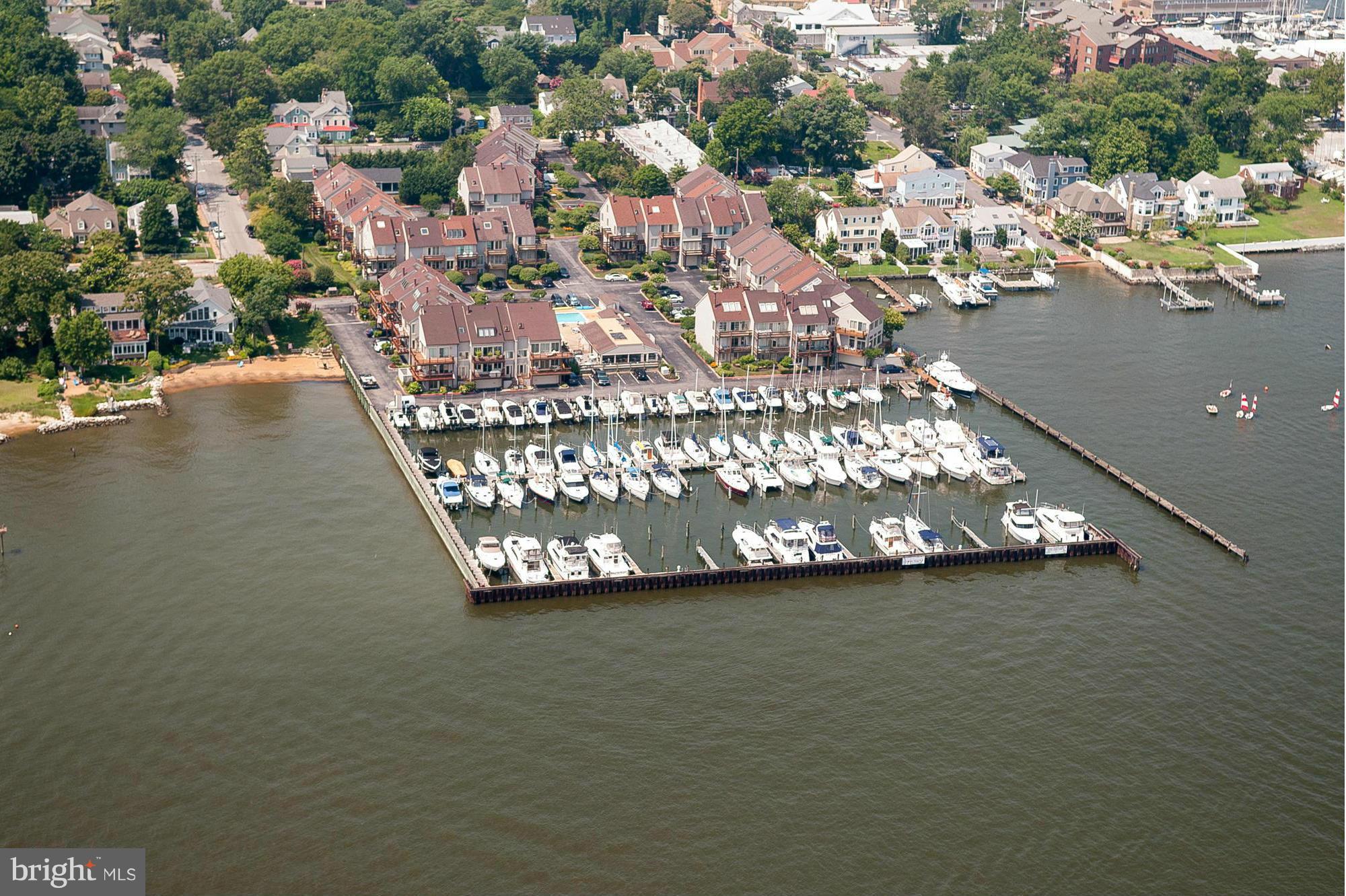 Luxurious, contemporary townhome with a waterfront view to the Severn and Bay. Home with a 2-car garage and elevator to 3 levels in a friendly, yet gated yacht club community. Easy walk to town and Eastport restaurants = a great location. Large, beautiful kitchen overlooks the pool. LR, MBR, loft and decks have dynamite views to the Bay. Three BRs, 3.5 BA plus loft. Beautifully updated.NEW PRICE!