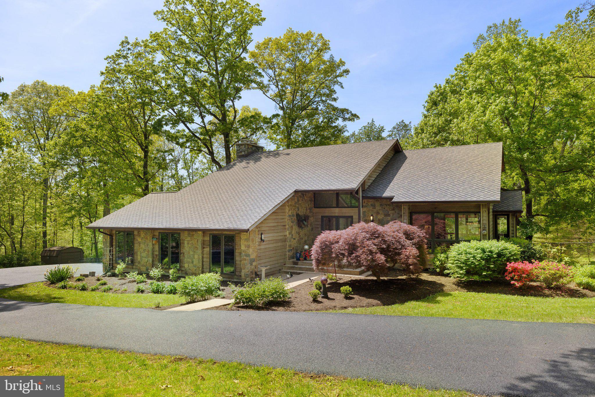 Modern Country Retreat on 5 Private Acres – Western Loudoun, close to Leesburg. Discover refined living in this very well-maintained,  architecturally unique contemporary home, tucked away on 5 private acres just minutes from the Rt 7/9 interchange and Harmony Park & Ride. Inside, enjoy a bright, open floor plan with a stunning two-story living room, gourmet kitchen, and spa-like primary suite with treetop views.
The fully finished walkout lower level offers flexible space with two legal bedrooms, a full bath, and a second family room. Outside, a 40' x 60' barn—currently used for dog agility—offers endless potential for storage, hobbies, or vehicles.  Fully fenced sunny backyard, expansive deck, large concrete patio and wooded serenity complete this rare Western Loudoun gem.  Very well maintained.  Roof & gutters replaced in 2021
Open floorplan. Private lot. Convenient access. Your perfect retreat awaits.