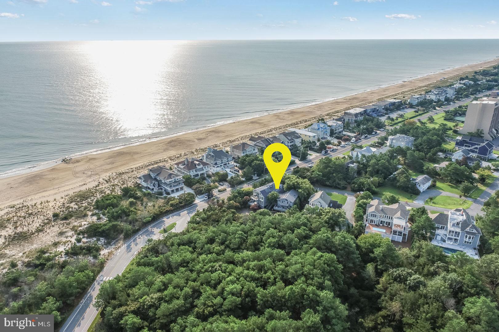 Modern Masterpiece describes this distinguished home located at 61 Ocean Drive in the prestigious North Shores community.  This property features a superb location offering the utmost convenience to the community’s private beach, community pool, marina, tennis courts and to the popular Gordon’s Pond Trail.  Situated on a spacious perimeter parcel adjacent to Cape Henlopen State Park allows for extreme privacy and views for miles. Originally built in the 60’s and completely revamped between 2001 and 2006, this home leaves little to the imagination.  Designed by architect John Mateyko and built by Ocean View based builder, Jelock Builders, this 7-bedroom 5.5 bath home is like no other in the area.  Attention to design offers endless views of the ocean and state park from almost every room and living space of this +/- 6,000 square foot home. Soaring ceilings, exposed beams, many windows, maple floors, cabinetry, built-ins, and contemporary lines compliment this unique floor plan complete with a private guest wing.  Multi-levels of balconies, screened porches and sundecks offer space for all guests. The spacious yard offers fun and entertainment for all complete with a hot tub, Bocce Ball court, horseshoe pit, and badminton court. This home was featured in the 2018 Delaware Beach Life as “Modernism and Maple”.