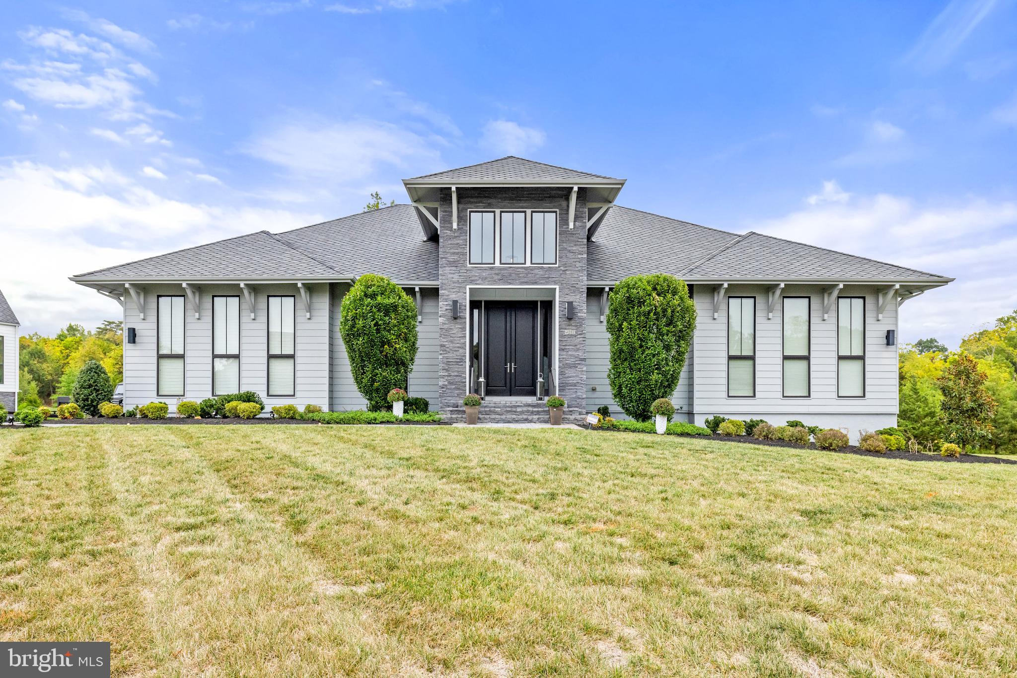 BREATHTAKING EURO STYLE  LINE K NOODERWIND MODEL IN SOUGHT AFTER GRANT ESTATES WILLOWSFORD ON  ALMOST AN ACRE PREMIUM CORNER LOT ADJACENT TO CONSERVATION LAND WITH PREMIUM UPGRADES THROUGHOUT THE HOME! This Energy Efficient home is an epitome of luxury, abundance of natural light, bespoke craftsmanship details with perfect blend of contemporary & functionality designed by renowned Dutch Designer Piet Boone.Indeed one spectacular HOME !! A Rare Opportunity !!! Open the Grand Front doors & step into a Luxurious foyer , SOARING 12 feet Ceiling !! Open Concept Layout, Gorgeous Dining Room and Stunning double door library , Grand Foyer flowing into a Designer Gourmet Kitchen with custom quartz countertops with expansive island and built-in dining area along with a breakfast nook open space, Modern Linear FirePlace in Family Room which opens into a large covered Porch with Phantom Screening making one Huge Indoor & Outdoor Space to enjoy overlooking breathtaking views of a beautiful backyard oasis with landscape lighting and irrigation system, stair connect to lower level covered hardscape patio. Home features another study/home office perfect for remote work or telecommunicating. Spacious Pantry Closet with upgraded shelving.One of a Kind First floor owner's suite with Stunning state of Art Spa-like Owner's Bathroom with oversized showers & large walk-in Closest. Side entry Oversized 3-car garage with Oversized Wayne Dalton Contemporary Garage doors. Dual Zone heating and cooling & Central Vacuum !!! Sound system installed throughout the 2 levels perfect for entertainment. Lower level boasts another space perfect for Entertainment a wet bar and abundance of windows with natural lights flowing throughout with a lower level opening into a hardscape patio overlooking the stunning private oasis . A bonus spacious ensuite with full bath. Exercise room  and bonus room to customize & Much More !!!
Detailed Set of Features are attached in the Documents Section of MLS.
Award-Winning Willowsford offers numerous Amenities - Resort-Style Pools, Boat House, Clubhouses, Fitness Center, Demonstration Kitchen, Fitness Facilities, Working Farm, Outdoor Amphitheater, Year-Round Community Event Programming, Trails, Parks, Playgrounds, Zip-Lining, Campground, Ponds, Kayaking, and More! Easy access to Dulles Airport , toll roads , metro & commuter routes.