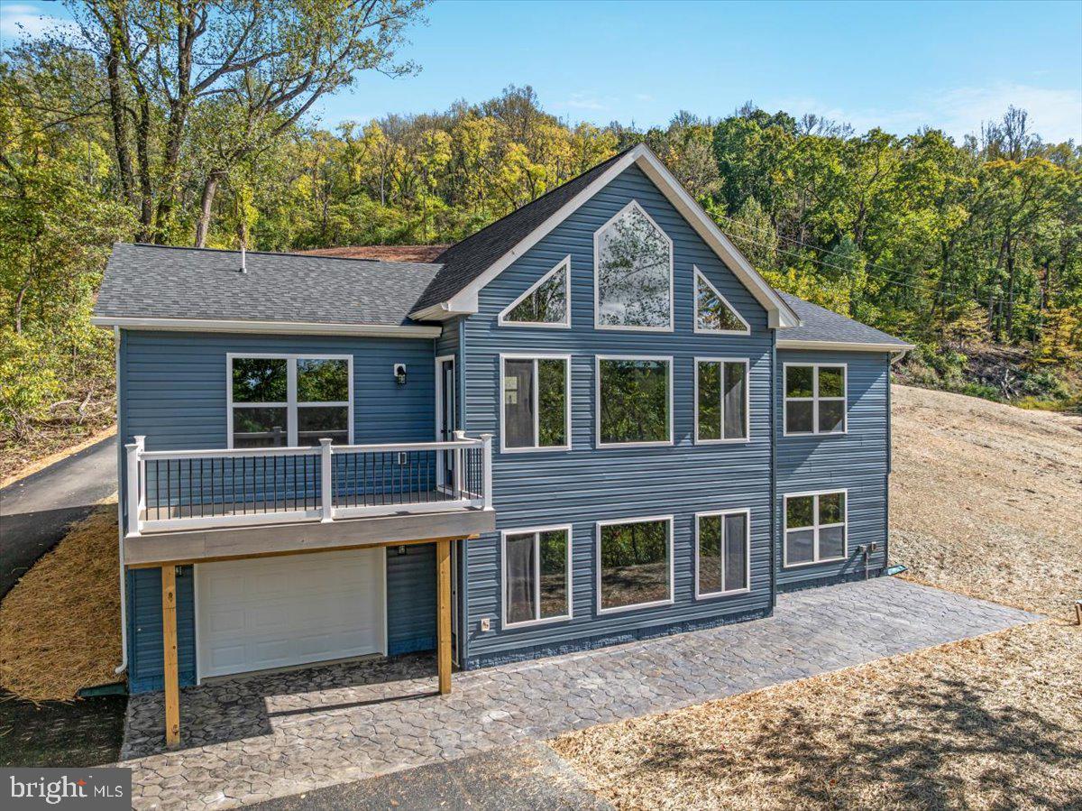 CONSTRUCTION HAS NOT BEEN STARTED - CURRENT PHOTOS ARE SIMILAR PHOTOS FROM A PREVIOUS BUILD.   CONSTRUCTION WILL BEGIN IN AUGUST! !  complete in approx 120 days 

If you’ve been dreaming of a mountain getaway or a place to call home full-time, this beautiful new chalet offers the perfect blend of style, comfort, and views. Tucked on .86 acres near the end of the street, this home gives you privacy, peace, and space to breathe.

Step inside and you’ll fall in love with the vaulted great room, filled with windows that bring in natural light and showcase the views. The open layout flows into a stunning kitchen with quartz countertops, center island, stainless steel appliances, and recessed lighting throughout—perfect for gathering and making memories.

This 3-bedroom, 2-bath home features a thoughtful split-bedroom design for added privacy. The primary suite includes a walk-in closet, double vanity, and a beautiful tile shower—your own private retreat.

Enjoy the outdoors on the front deck, where you can relax, take in the mountain air, and unwind. Luxury vinyl plank flooring runs throughout for durability and easy maintenance.

The walk-out unfinished basement offers room to grow—create a family room, guest space, or more. A 1-car garage adds convenience, and large windows on both levels keep the home bright and inviting.

Built by a local builder, this home blends quality craftsmanship with modern finishes.

Short-term rentals may be allowed—buyer to verify.
Photos of the home are of a similar property. Land photos will be added 4/17.

Don’t wait—schedule your showing today and start planning your mountain lifestyle!
What makes this area appealing?
Buyers love the mountain views, peaceful setting, and access to outdoor recreation, creating a relaxing place to live or visit.

Is this home suitable as a vacation or investment property?
Yes, the design and location make it ideal for a primary home, weekend getaway, or potential rental (buyer to verify local guidelines).

Are there opportunities to expand the home?
Absolutely. The unfinished walk-out basement gives you flexibility to add more living space in the future.

What outdoor features does the home offer?
The front deck and large windows allow you to enjoy the views and fresh mountain air year-round.

Who built the home?
The home is being constructed by a local builder, offering quality craftsmanship and attention to detail.