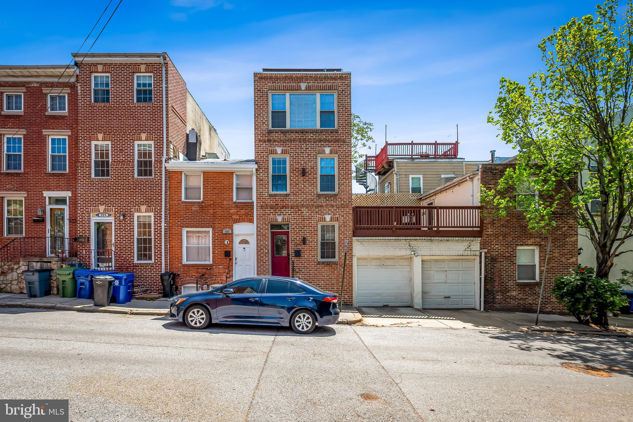 Recently renovated, this rowhome is what you have been waiting for with 4 finished levels, a rooftop deck with WATERVIEWS, and garage PARKING. Incredibly convenient location, this home provides easy access to both Canton and Fells Point. The open concept main living level with the coffered ceiling, hardwood floors, and exposed brick wall, gives this home Baltimore character. The large kitchen has lots of storage in the wood cabinets, tile floors, a skylight, granite counters, an oversized sink, counter to ceiling tile backsplash, numerous recessed lights, and stainless steel appliances including a range hood. Each of the upper levels and the finished lower level has a bedroom and bathroom.  The bedroom located on the second floor has its own balcony as well as a hall bathroom, with a tile surround shower/ bath, and an oversized granite vanity counter. The primary suite on the 3rd floor has a walk in closet and a wall of windows that flood the room with natural light. The bathroom has a dual sink vanity and a 5 showerhead tile-enclosed shower, complete with a seat. Easy access to the roof deck from the hallway (no going through a bedroom to get to the deck) with a wet bar conveneintly located just outside the door to the deck. The finished basement allows for a potential 3rd bedroom or office space. The basement hallway has large storage closets, the washer/ dryer, and leads to the third bathroom, which has a marvelous shower with a rain shower head. Although you can access almost anything you want without a car, this location allows for easy driving access to downtown, I95, I695, I83, as well as green space in nearby Patterson Park and Canton Waterfront Park. This home comes with a 5 year lease for a parking space in the garage next door. The garage includes a high voltage outlet meant for an electric car charger. Property has dual zone heating and air conditioning for added efficiency. Located in the Hampstead Hills Elementary/ Middle zone. Freshly painted and cleaned, all you have to do is move in. Come tour today!