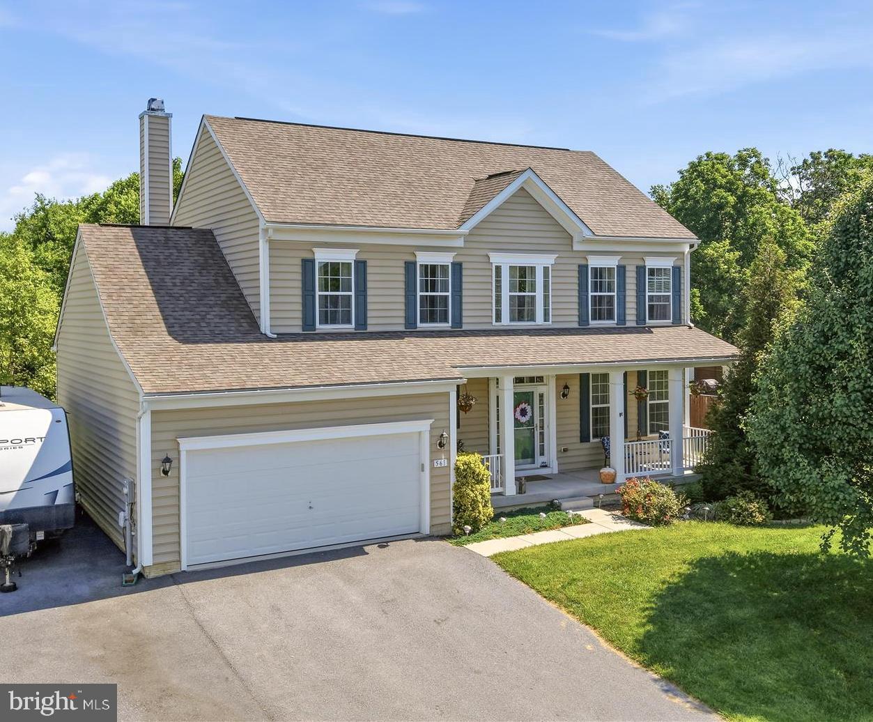Charming, spacious, and perfectly positioned, this 4-bedroom, 2.5-bath Colonial in Sheridan Estates blends timeless curb appeal with modern comfort. A welcoming rocking-chair front porch leads to a dramatic two-story foyer filled with natural light. The thoughtfully designed main level features formal living and dining rooms, plus an inviting family room with fireplace that flows seamlessly into the chef's kitchen and sunny breakfast area overlooking the 12' x 16' deck. Upstairs, the generous primary suite offers a relaxing retreat with a walk-in shower and dual vanities, while three additional bedrooms share a well-appointed hall bath. The unfinished walk-up basement includes a full bath rough-in, providing an outstanding opportunity to substantially expand the home's living space and customize it to your needs. Outside, the large, level backyard offers endless possibilities for recreation, gardening, play, or entertaining. A wonderful combination of space, comfort, and future potential awaits.