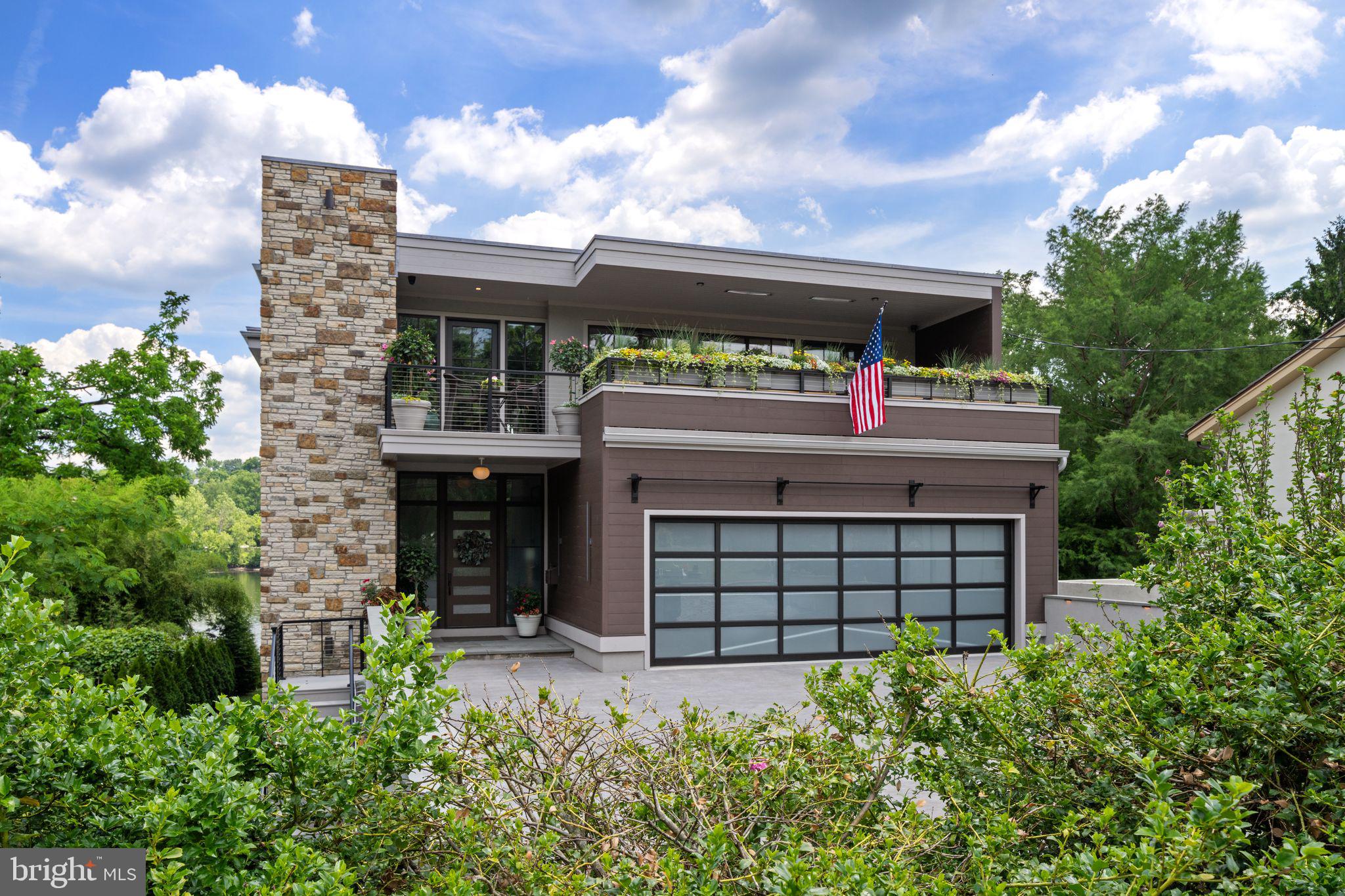 Modern Riverfront Estate with Unparalleled Indoor-Outdoor Living

Welcome to 182 S. Main Street, a rare opportunity to own one of New Hope’s few new-construction riverfront estates. Built in 2021 with every luxury in mind, this architectural showpiece blends cutting-edge design with the timeless allure of life along the Delaware River.

From the moment you enter the two-story foyer, you’re met with sweeping river views that flow throughout the home’s open living spaces. The main level features radiant-heated floors, a chef’s kitchen with  Sub-Zero refrigerators, wine refrigerator, and Wolfe gas stove and double ovens with warming drawer, plus a wet bar with sink, refrigerator, and ice maker—ideal for entertaining in every season. The adjoining family room opens to a spacious riverfront terrace, creating an effortless connection between indoor and outdoor living that is truly unparalleled. Additionally there is a half bath and laundry on the main level. 

The primary suite on the main level serves as a private retreat, complete with two large walk-in closets—one showcasing a sparkling chandelier and built-in TV for a touch of glamour—along with a spa-inspired bath.

Upstairs, you’ll find three additional bedroom suites, each with a private bath, as well as a dedicated office and an expansive family/media room with bar and an additional half bath and laundry. The upstairs bathrooms feature radiant-heated porcelain floors, and the family room boasts a 100-inch drop-down screen, wet bar with ice maker, microwave, refrigerator, and dishwasher, and panoramic river views. This versatile upper level can function as a private living area for family or  guests, with both front and rear terraces extending the space outdoors. 

The home’s roof deck offers one of New Hope’s most exceptional outdoor living experiences—a dramatic vantage point complete with a fireplace and unrivaled views of the river and fireworks, making it one of the area’s most spectacular private spaces.

The lower level continues the sense of luxury with 10-foot ceilings and radiant-heated floors throughout. The media and game room opens to a covered patio with built-in heaters and a private hot tub overlooking the water. From here, a floating dock provides direct access for boats and two jet skis, making river recreation effortless.

Car enthusiasts will appreciate the innovative car-lift system connecting the main-level garage to the lower level, accommodating four vehicles below, one on the lift, and two in the main garage—plus parking for five additional cars in the driveway. A large storage space beneath the driveway provides ample room for summer gear, river toys, and seasonal décor. There is also an additional storage space that has a garage door to the backyard, great for bringing water toys in or versatile storage space. 

Additional features include:
• Fully integrated smart-home system controlling lights, shades, and sound throughout
• Hardwired indoor and outdoor speaker system
• Professionally landscaped riverfront grounds

With its unmatched combination of design, technology, and river access, 182 S. Main Street stands as one of New Hope’s most remarkable modern estates—offering unparalleled indoor-outdoor living just steps from the heart of downtown.